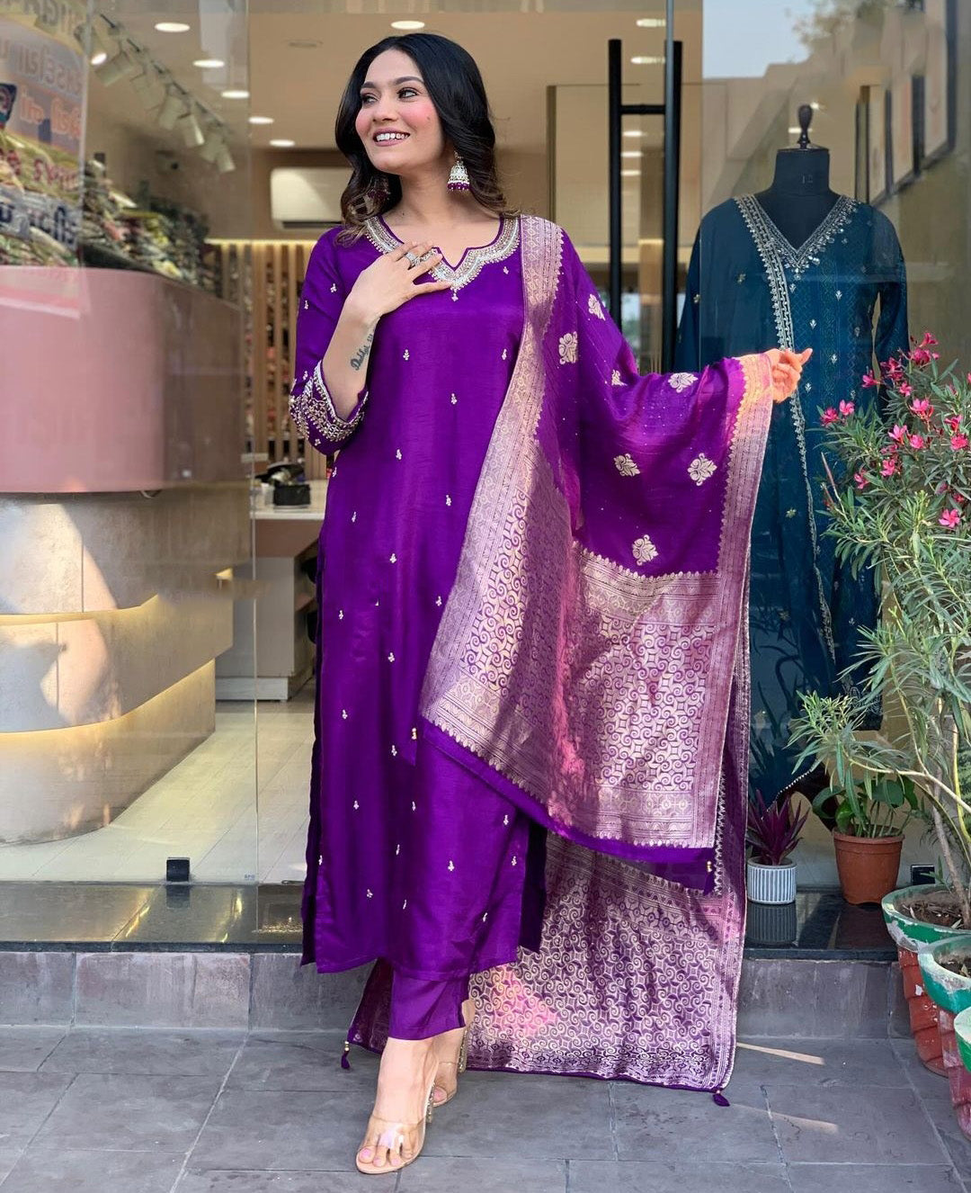 Woman in a purple traditional outfit with a matching dupatta.