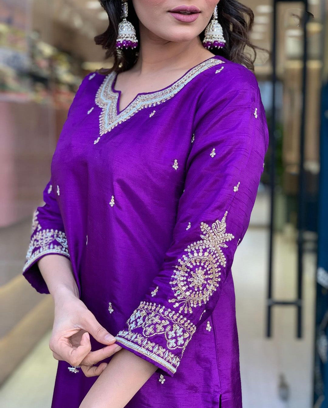 Woman in a purple traditional outfit with a matching dupatta.