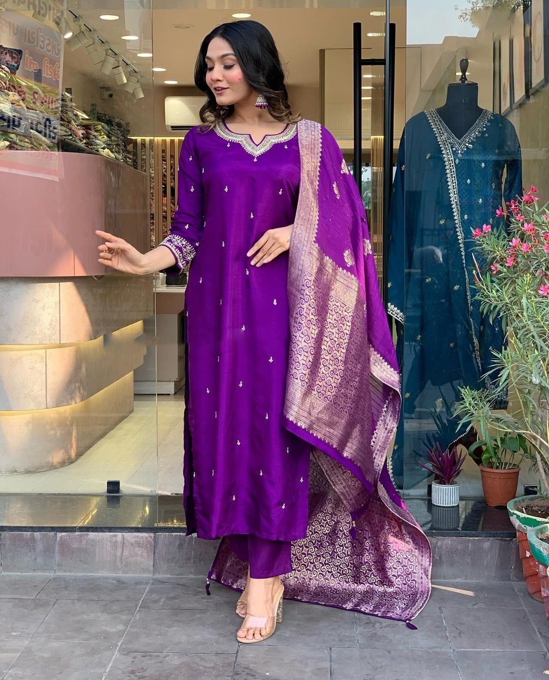 Woman in a purple traditional outfit with a matching dupatta.