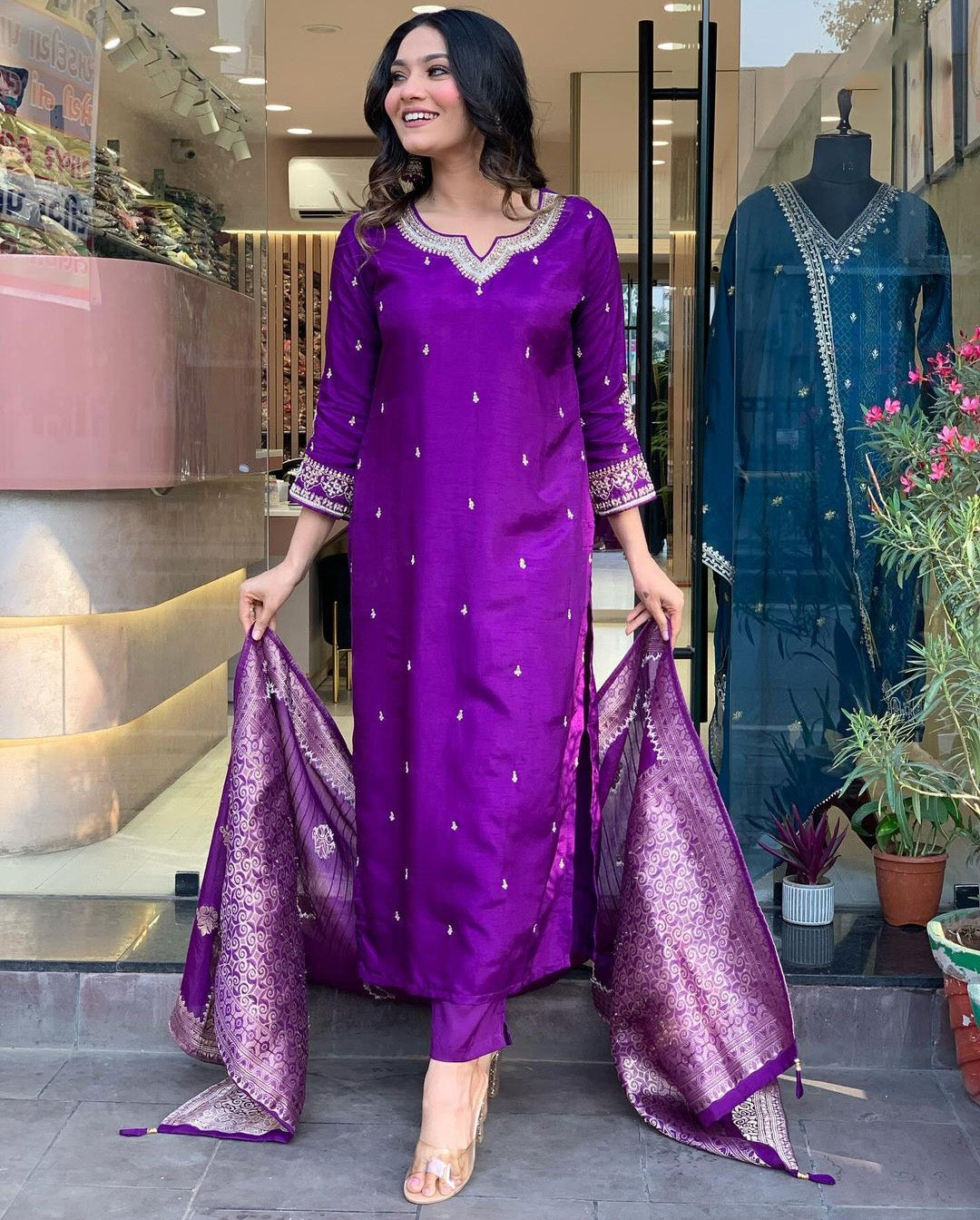 Woman in a purple traditional outfit with a matching dupatta.