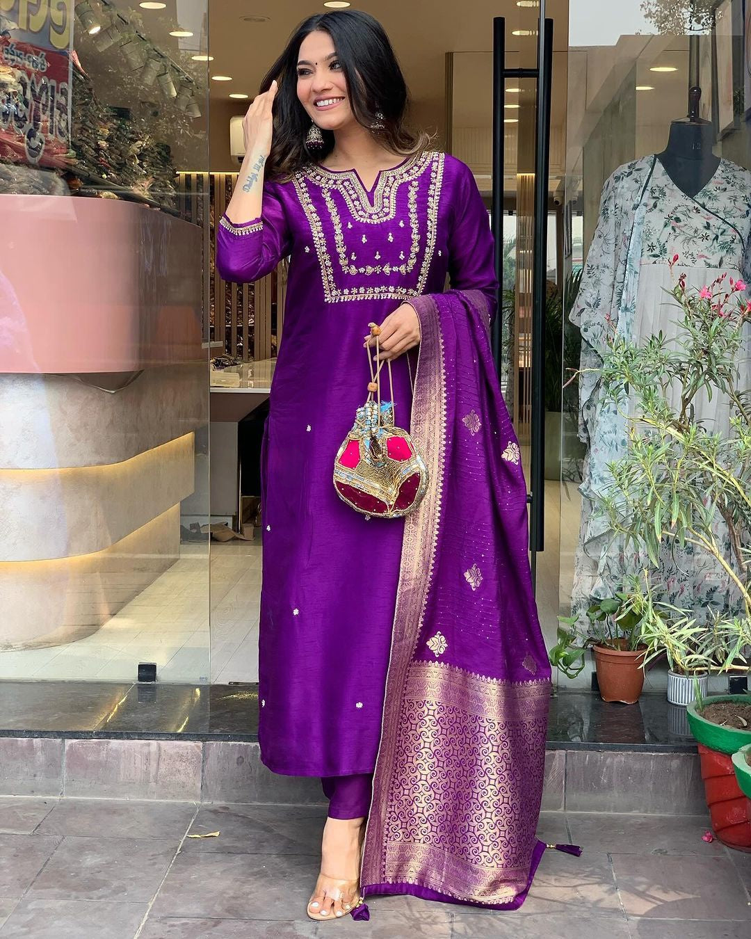 Woman in a purple traditional outfit .