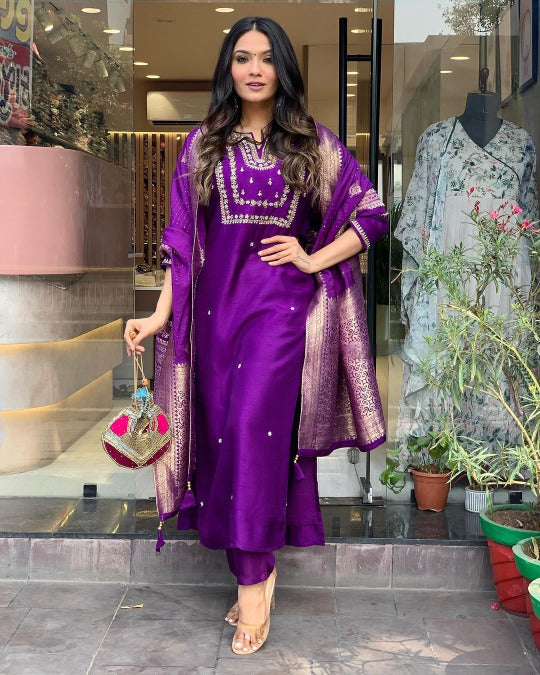 Woman in a purple traditional outfit .