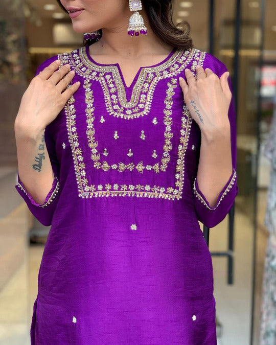 Woman in a purple traditional outfit .