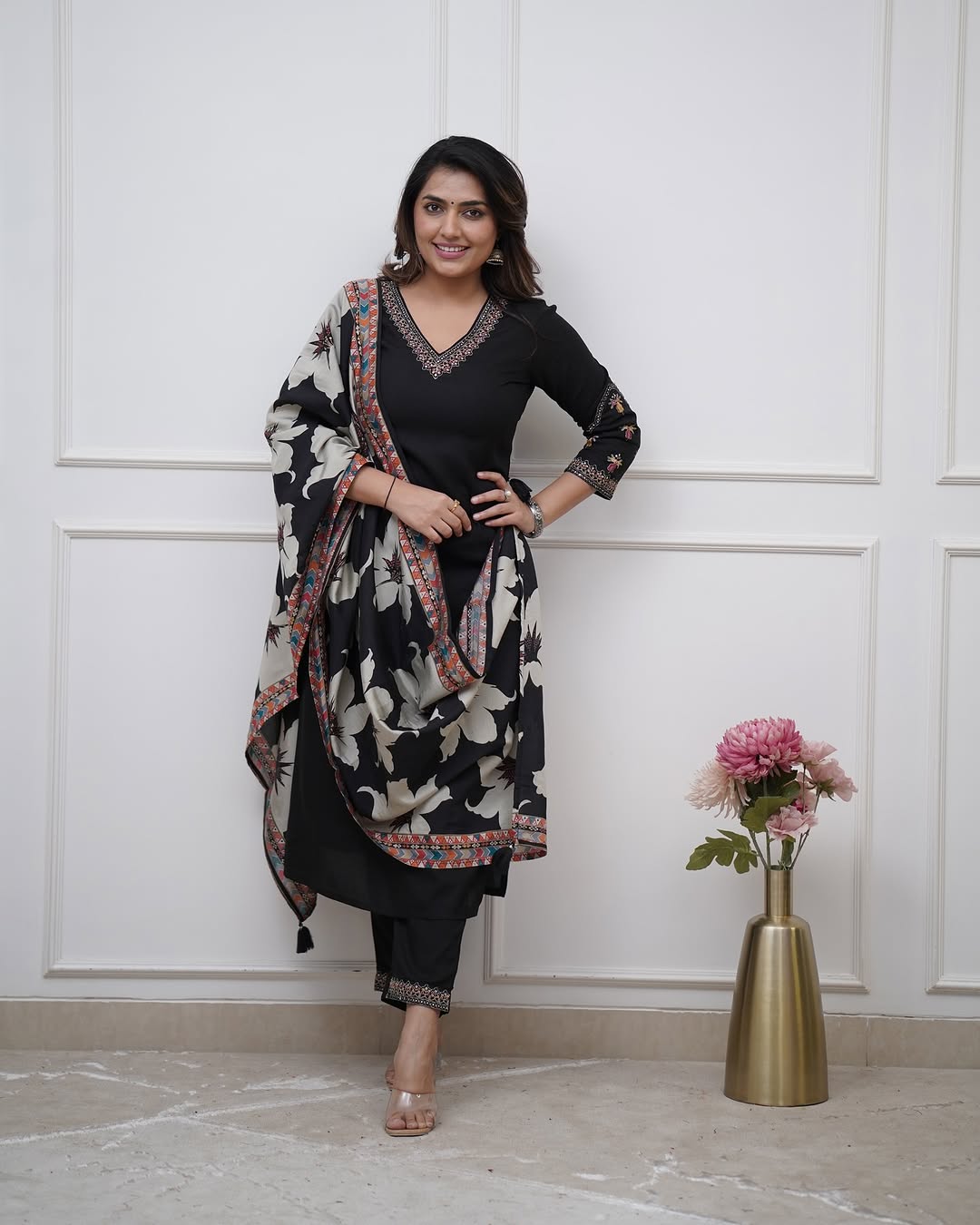Woman in black traditional outfit with floral dupatta