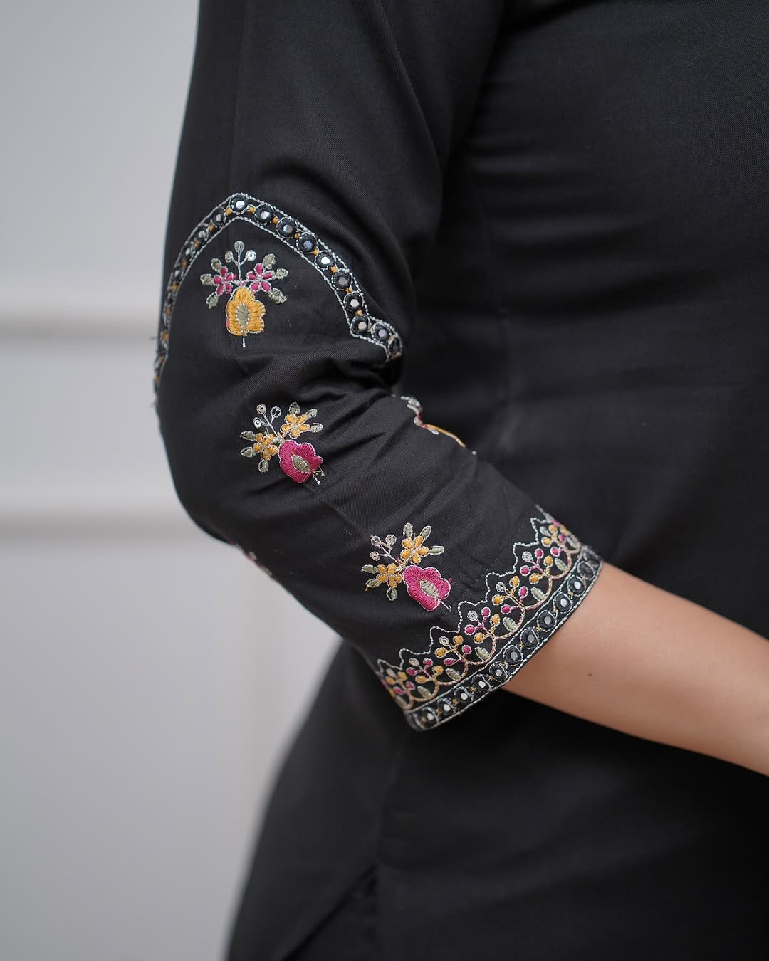 Elegant black suits adorned with intricate embroidery work