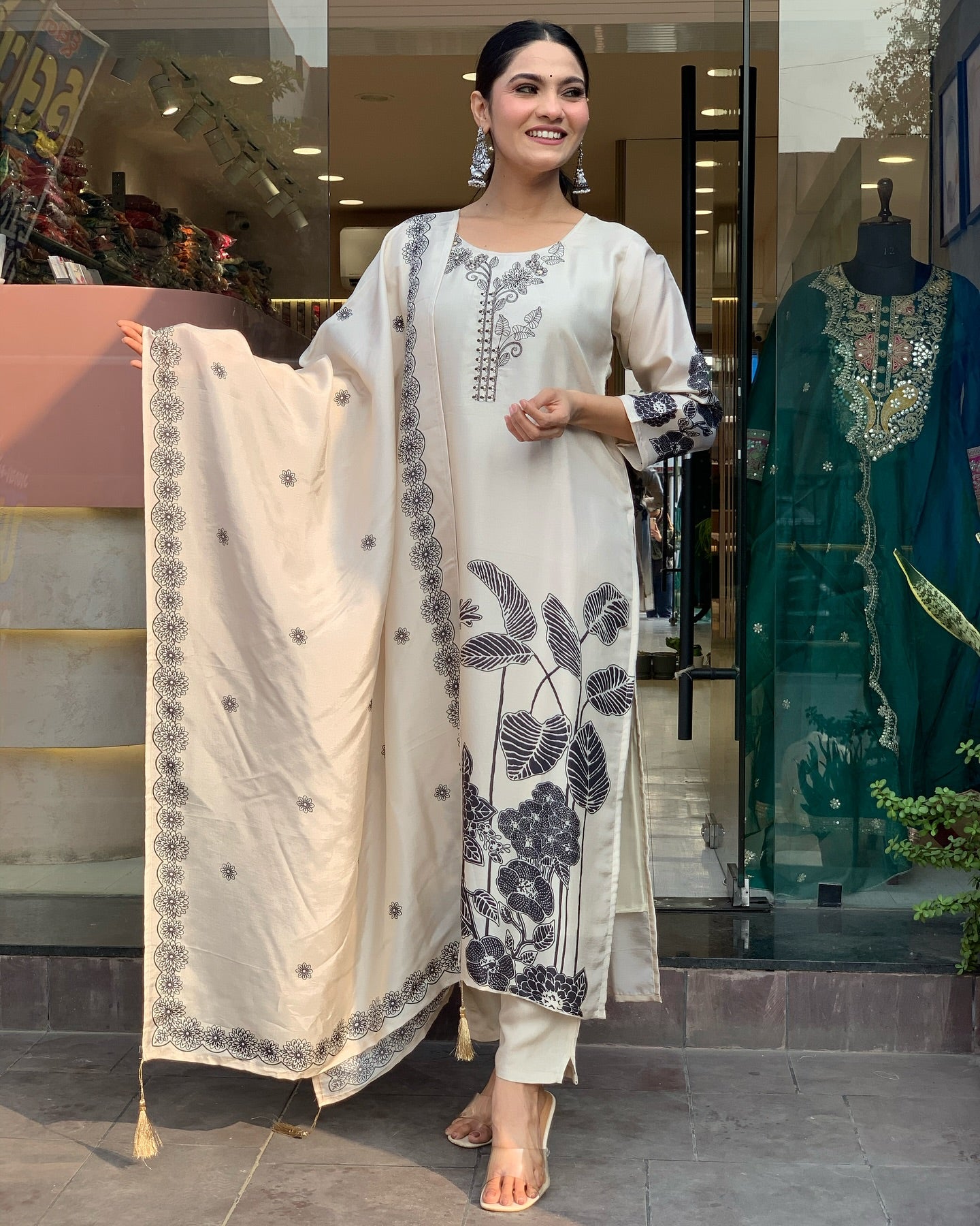 Woman in a floral black n white embroidery outfit