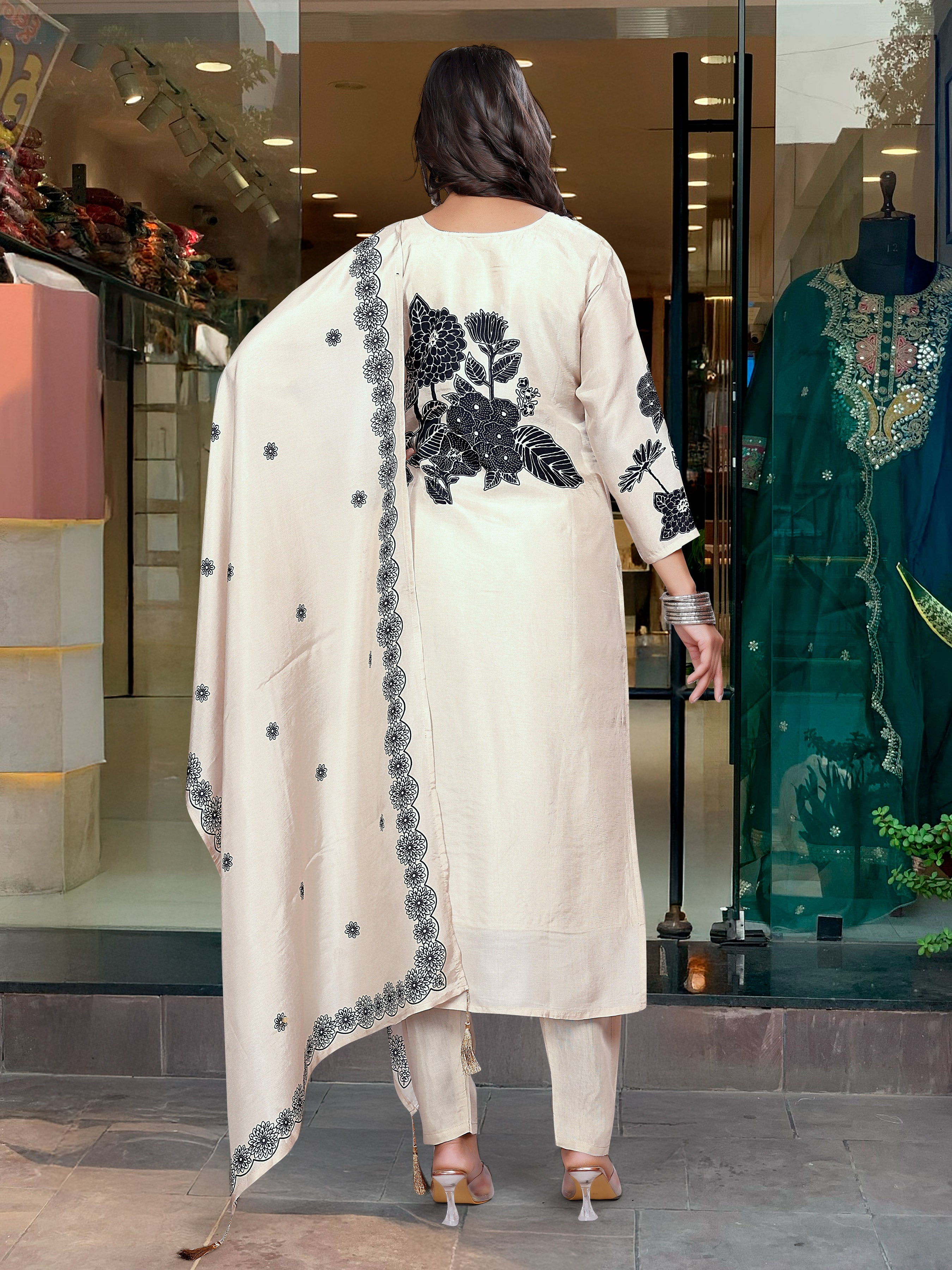 Woman in a floral black n white embroidery outfit