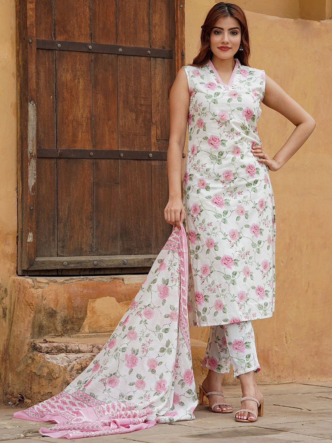 Woman wearing a floral outfit with a dupatta .