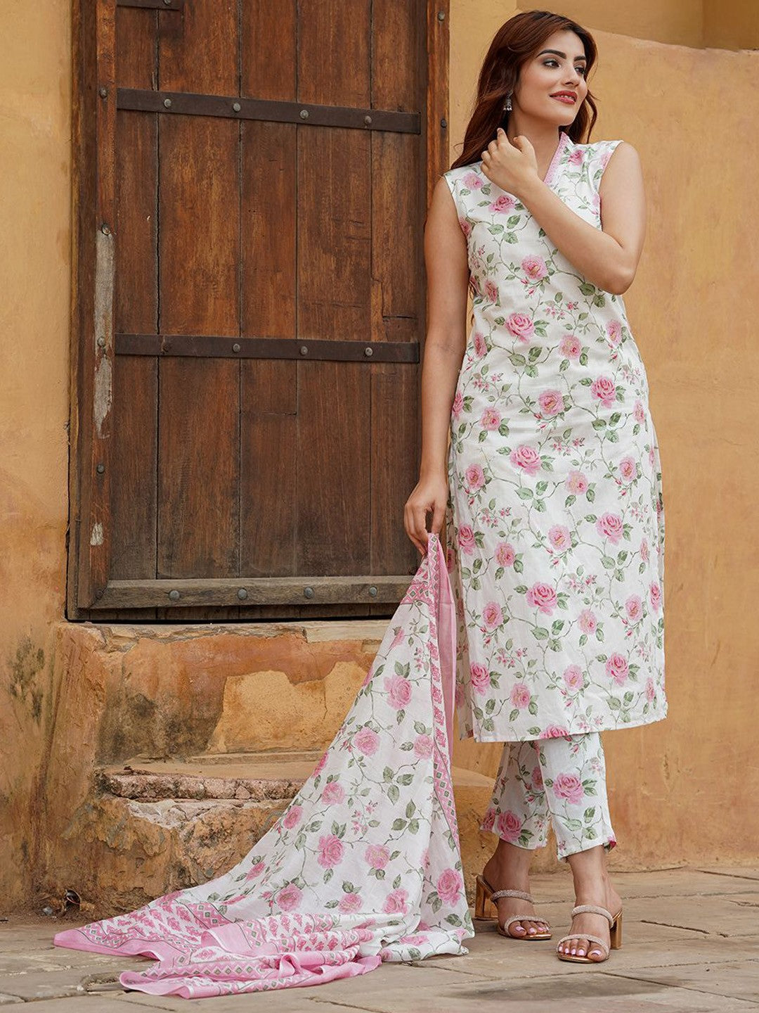 Woman wearing a floral outfit with a dupatta .