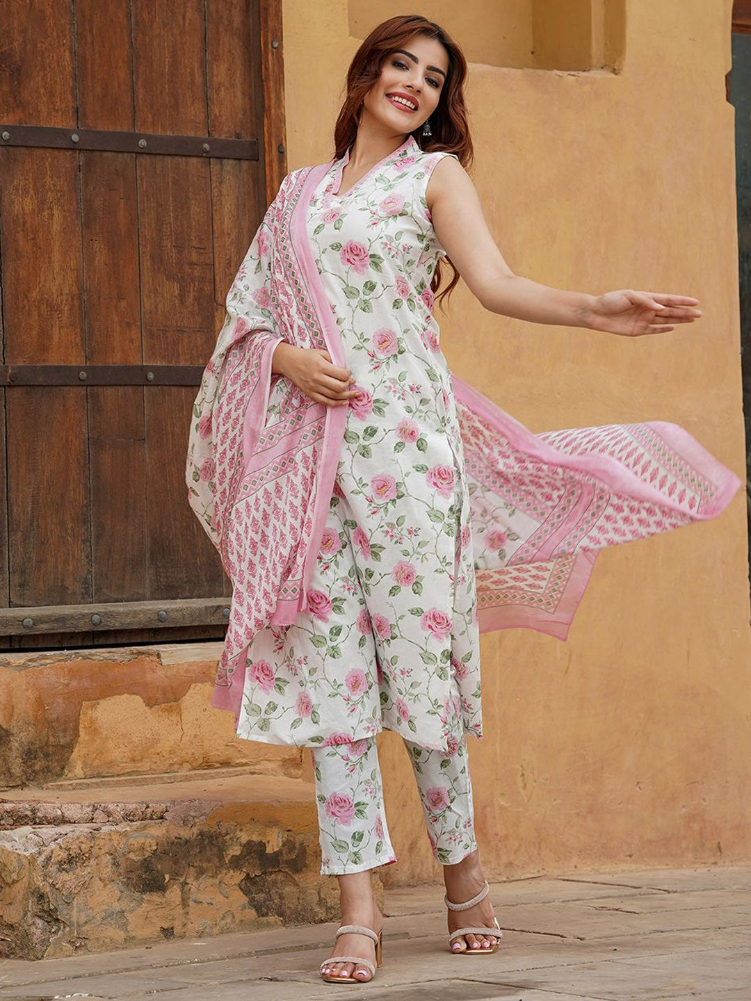 Woman wearing a floral outfit with a dupatta .