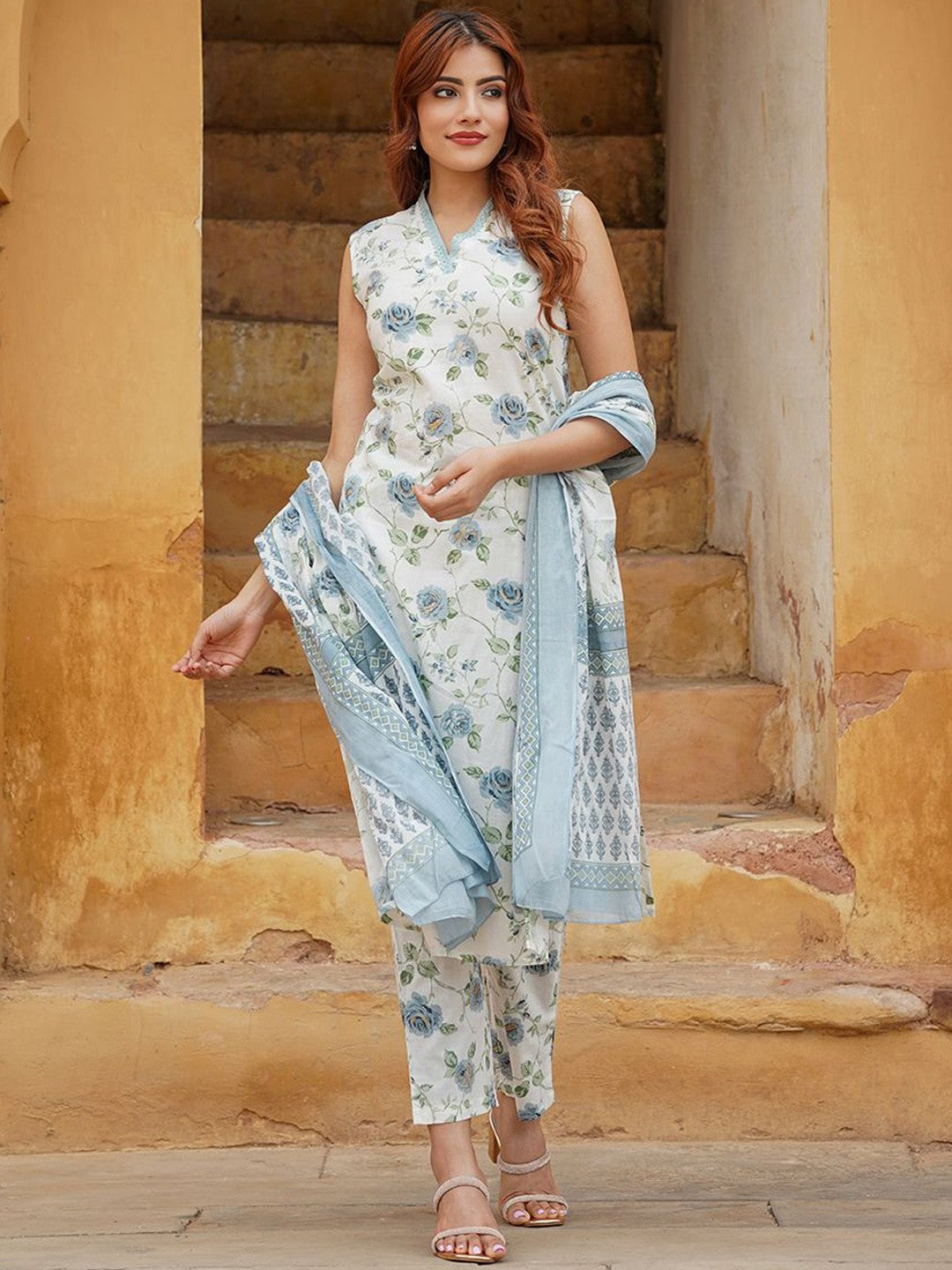 Woman wearing a floral outfit with a dupatta .
