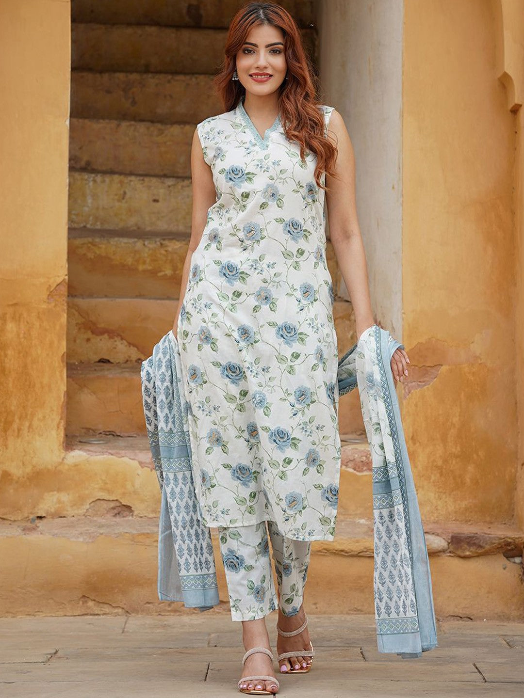 Woman wearing a floral outfit with a dupatta .