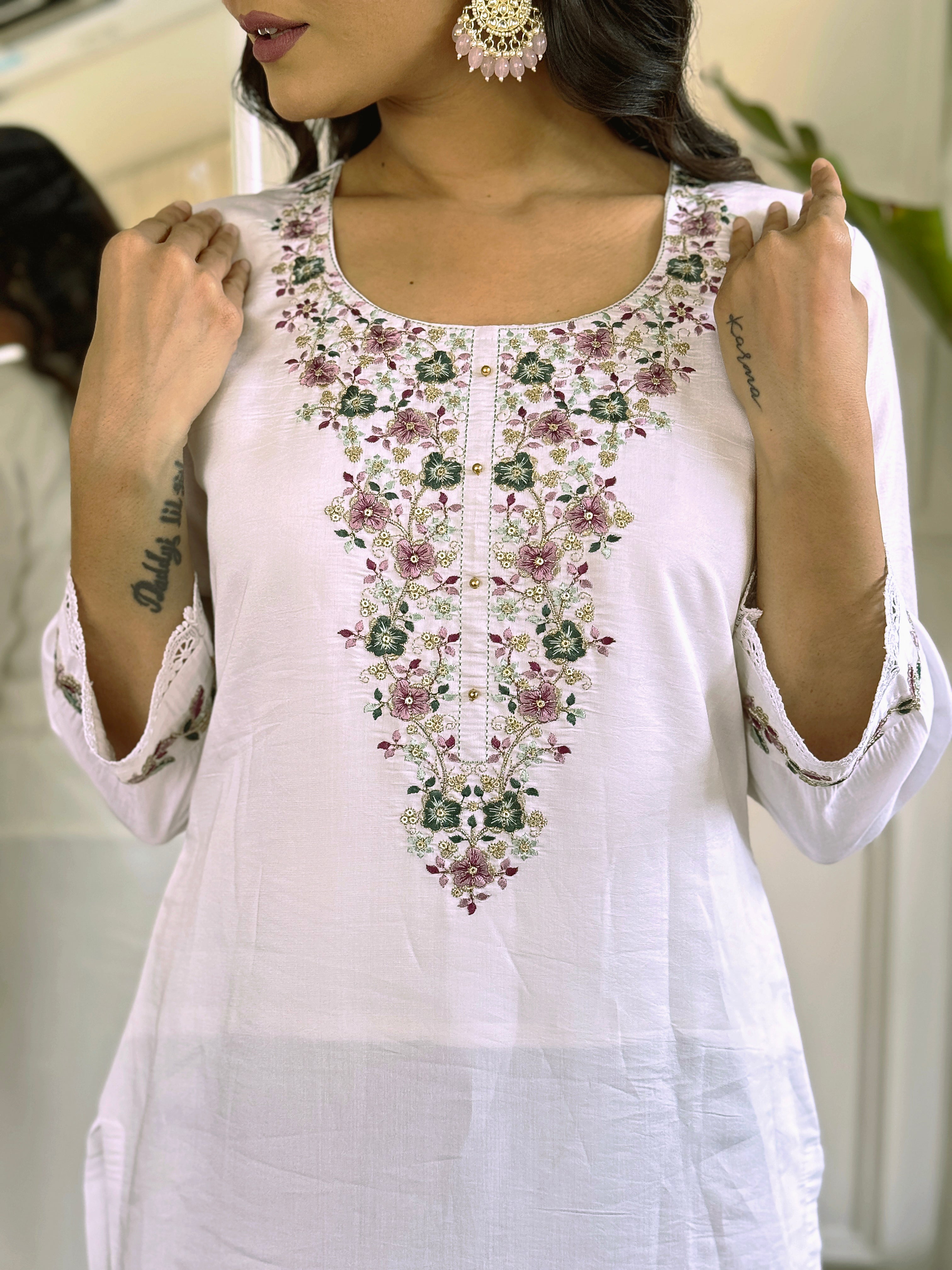 legant white salwar suit crafted from luxurious Viscose Chanderi fabric.