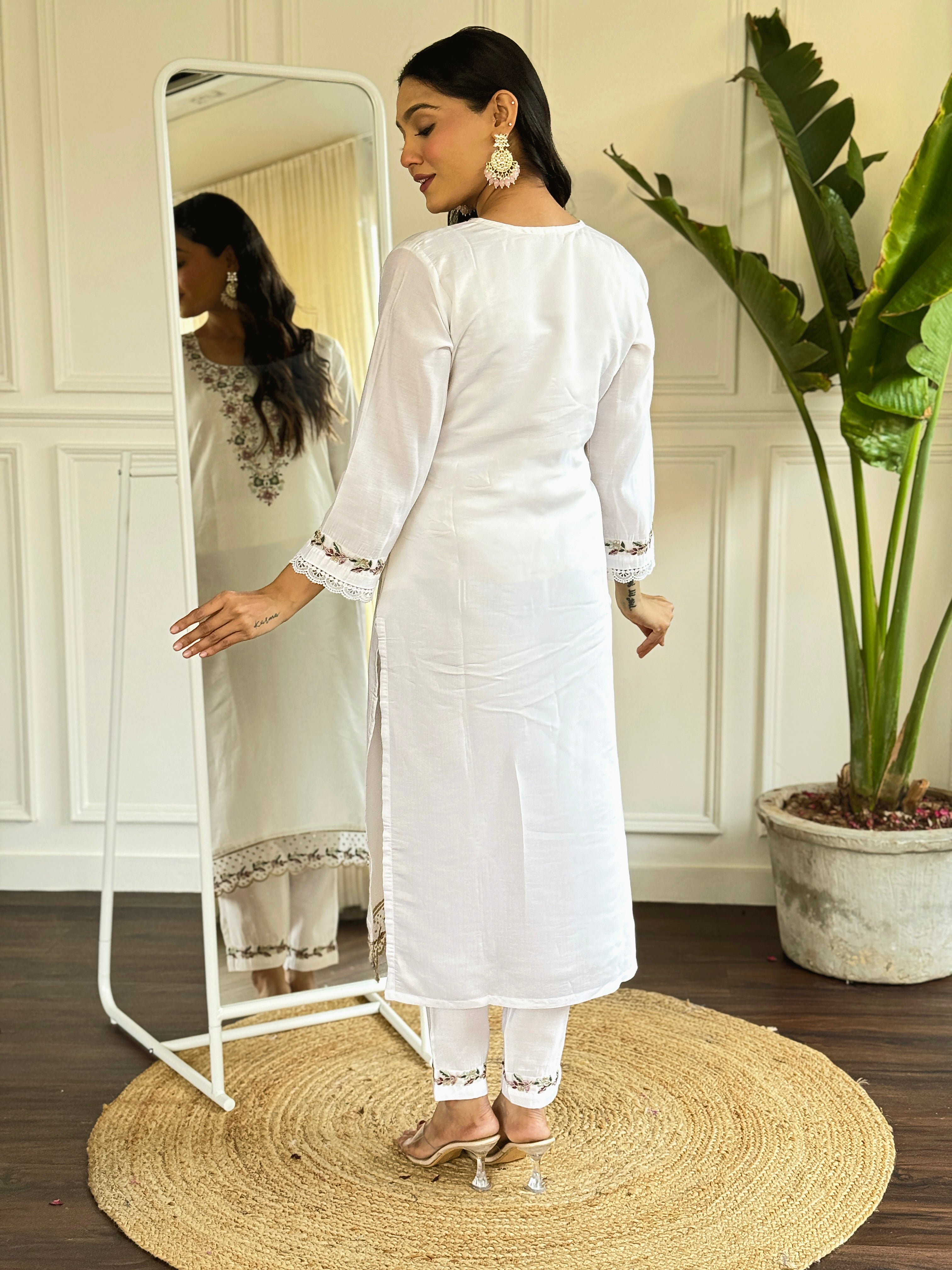 legant white salwar suit crafted from luxurious Viscose Chanderi fabric.