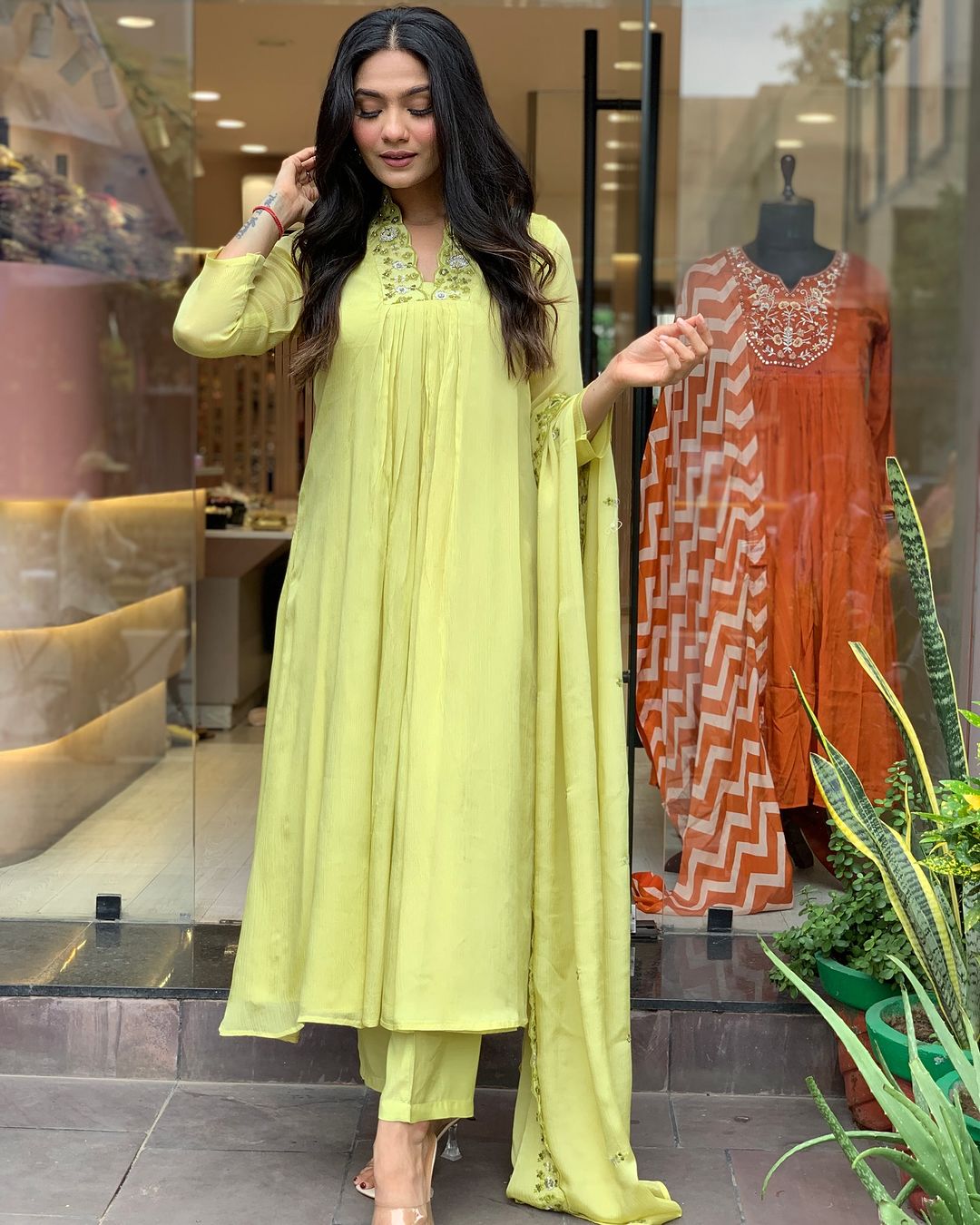 Woman in a light green traditional outfit with a matching dupatta