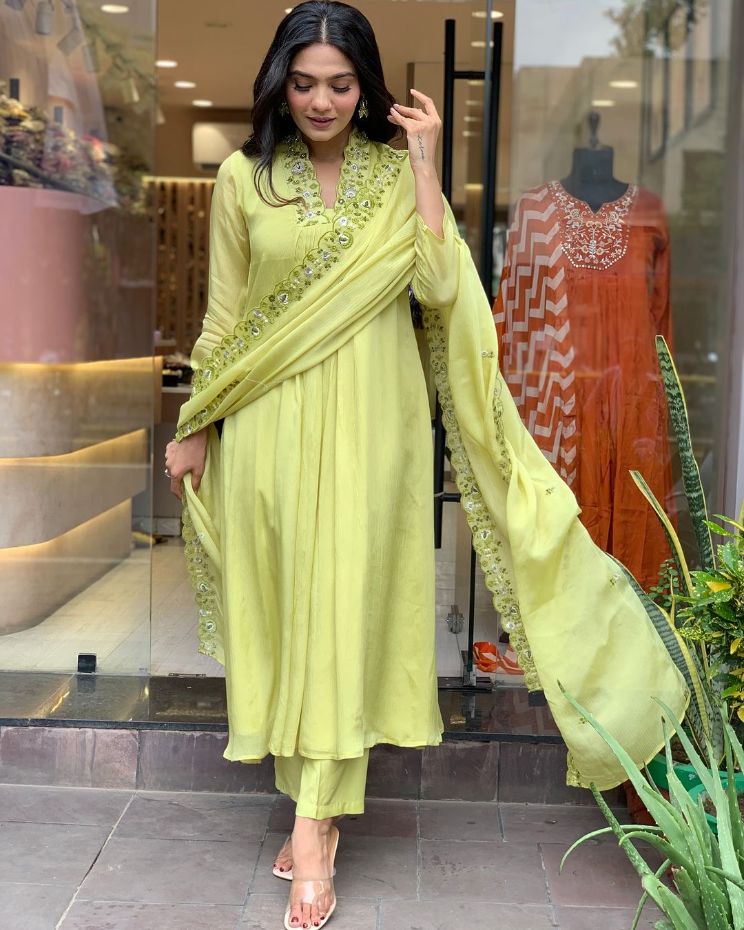 Woman in a light green traditional outfit with a matching dupatta