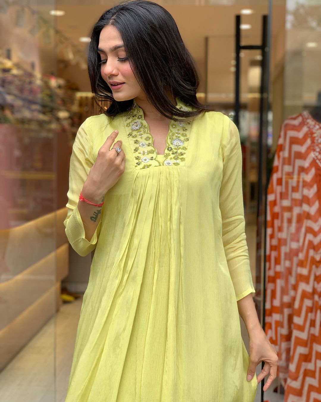 Woman in a light green traditional outfit with a matching dupatta
