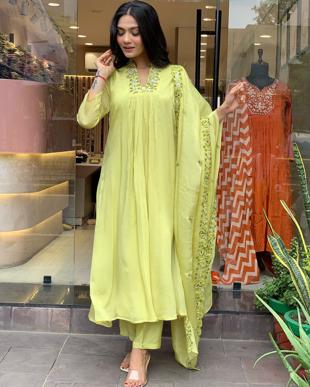 Woman in a light green traditional outfit with a matching dupatta