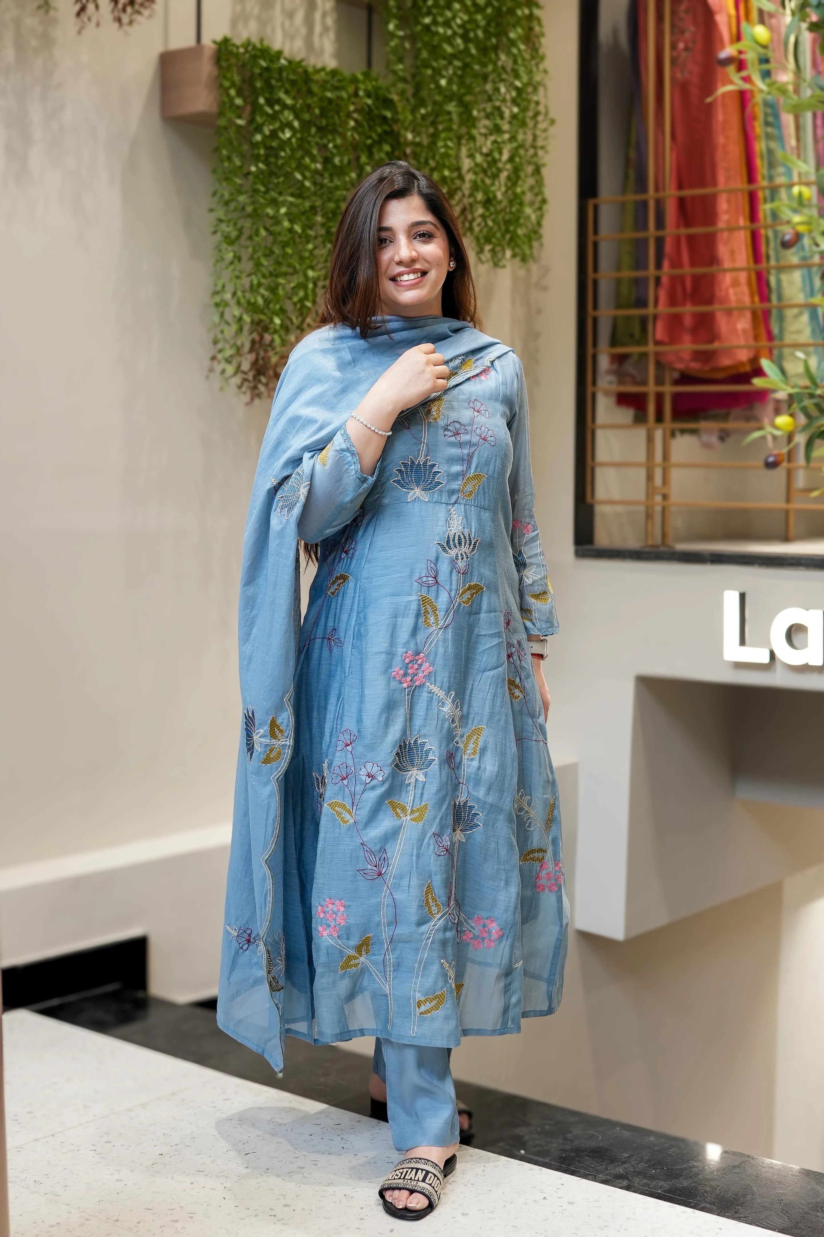 Woman holding a floral embroidered scarf