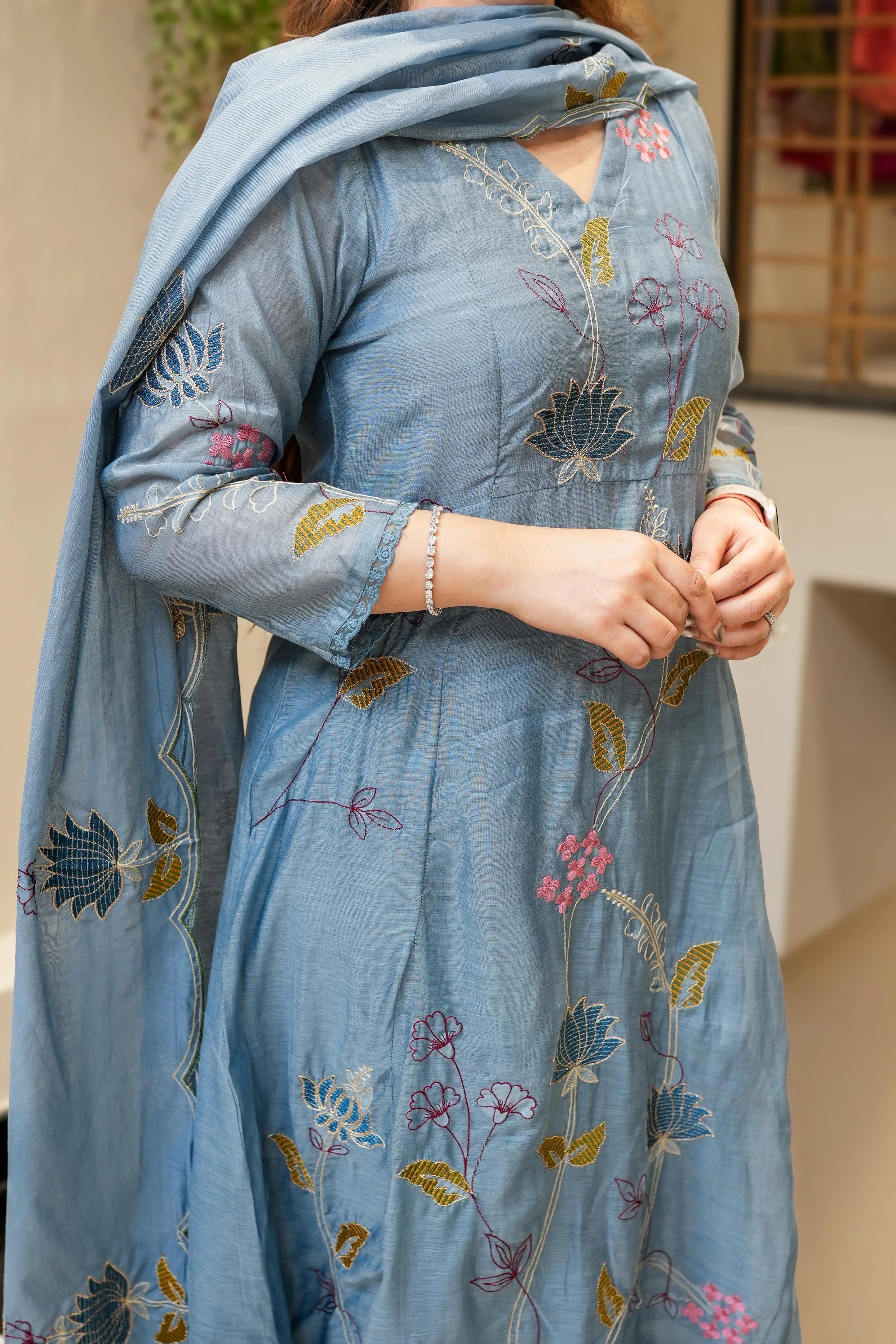 Woman holding a floral embroidered scarf