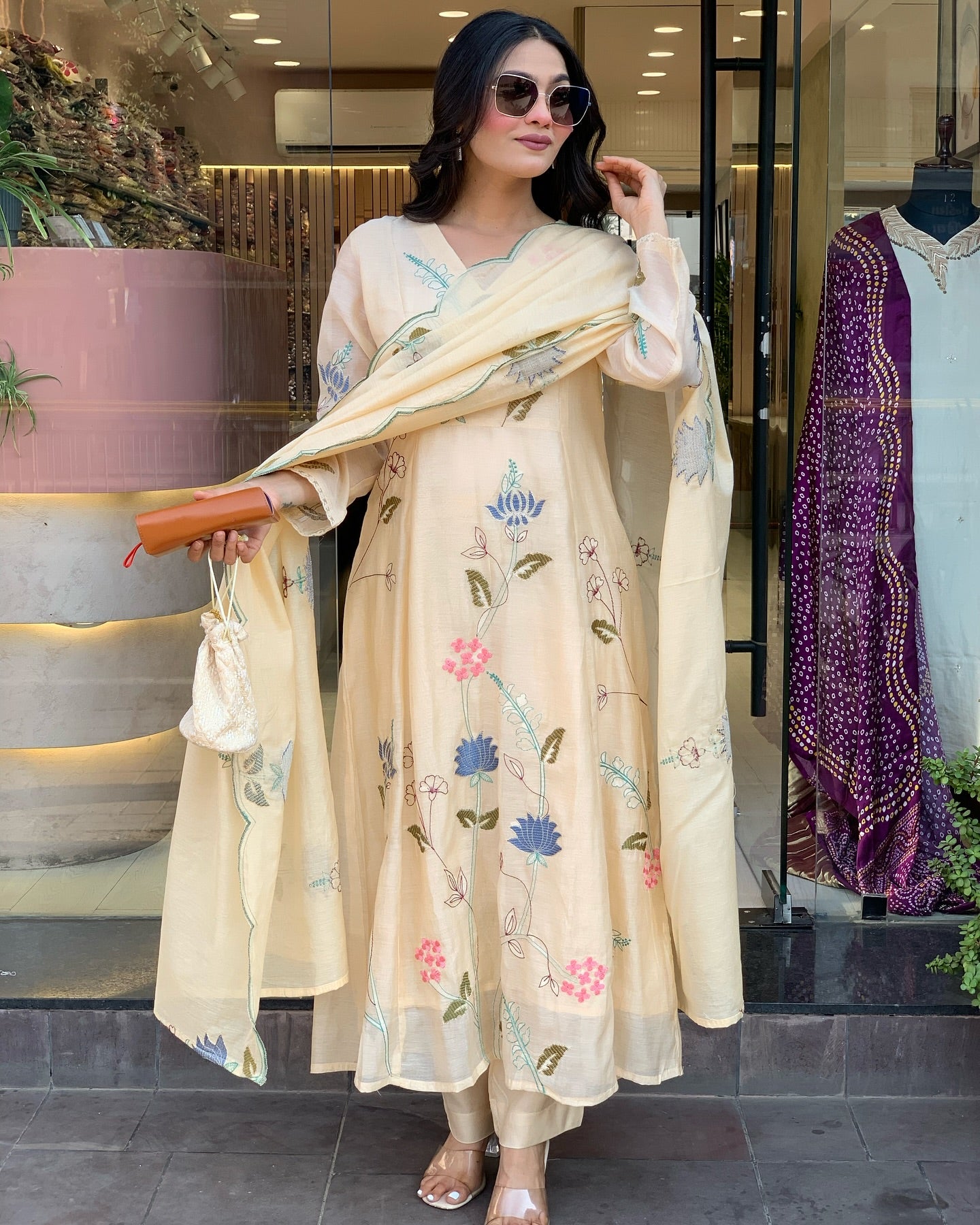 Woman holding a floral embroidered scarf