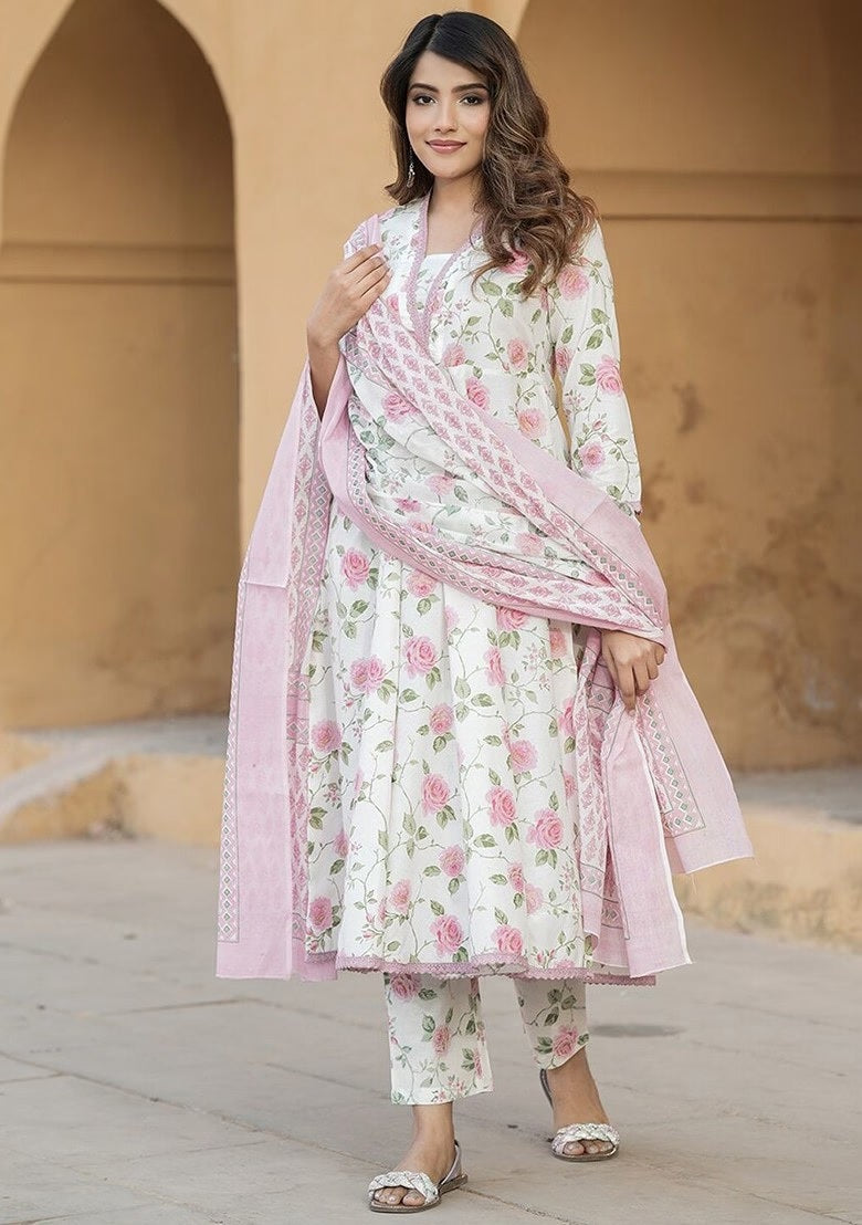wearing a floral outfit with a pink dupatta