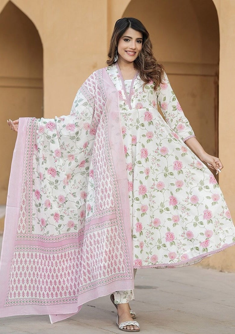 wearing a floral outfit with a pink dupatta