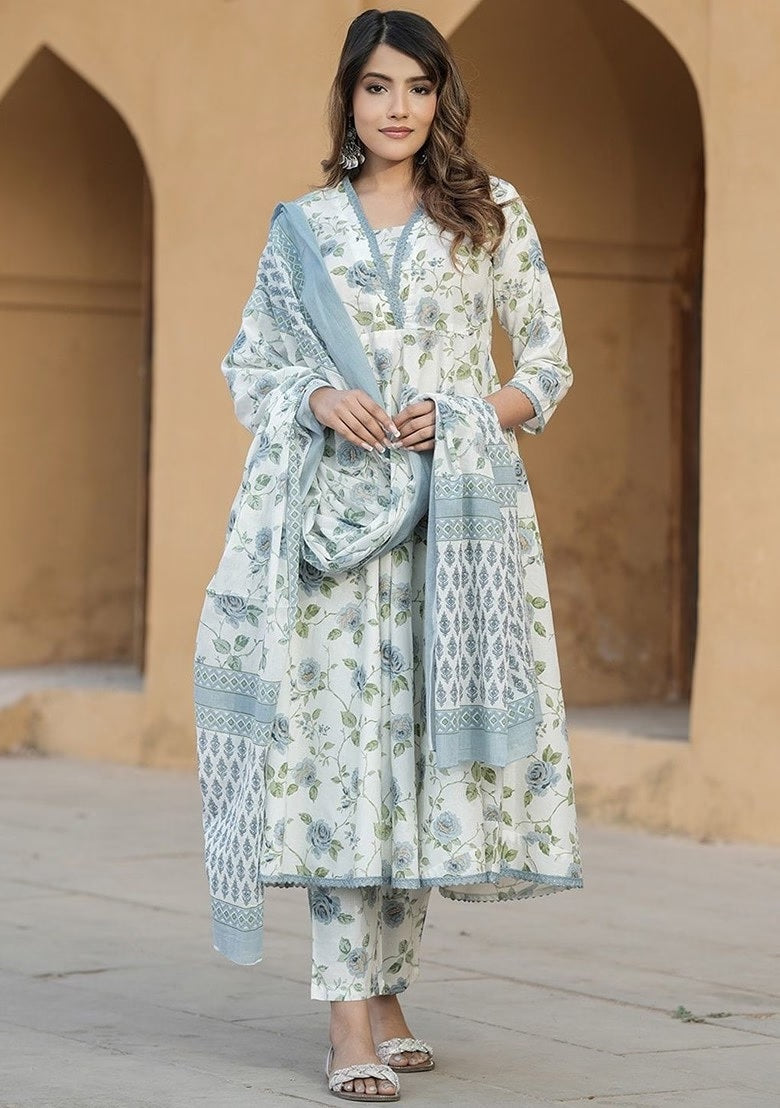 wearing a floral outfit with a pink dupatta