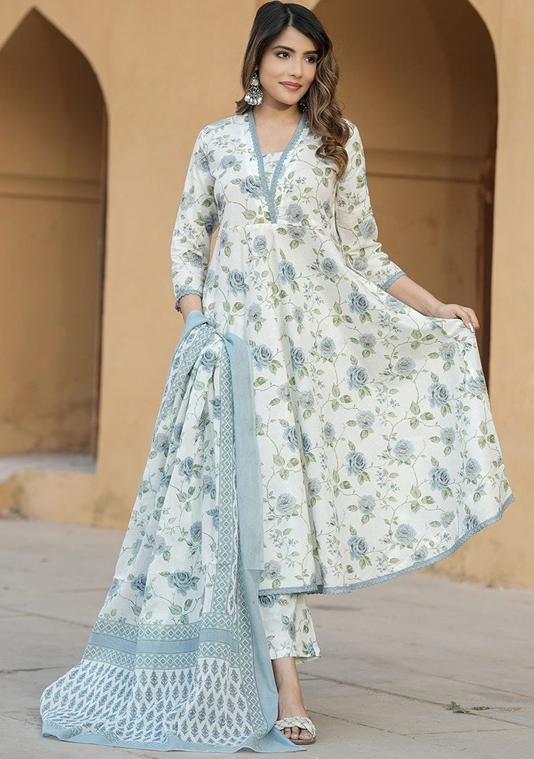 wearing a floral outfit with a pink dupatta