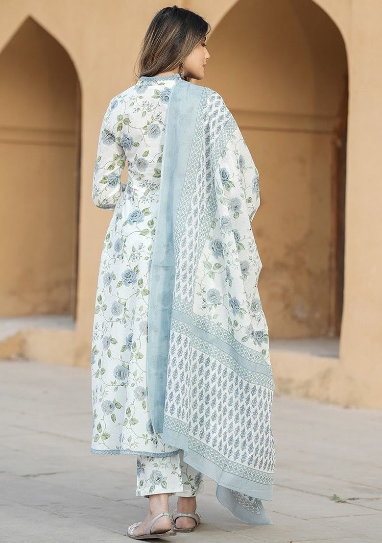 wearing a floral outfit with a pink dupatta