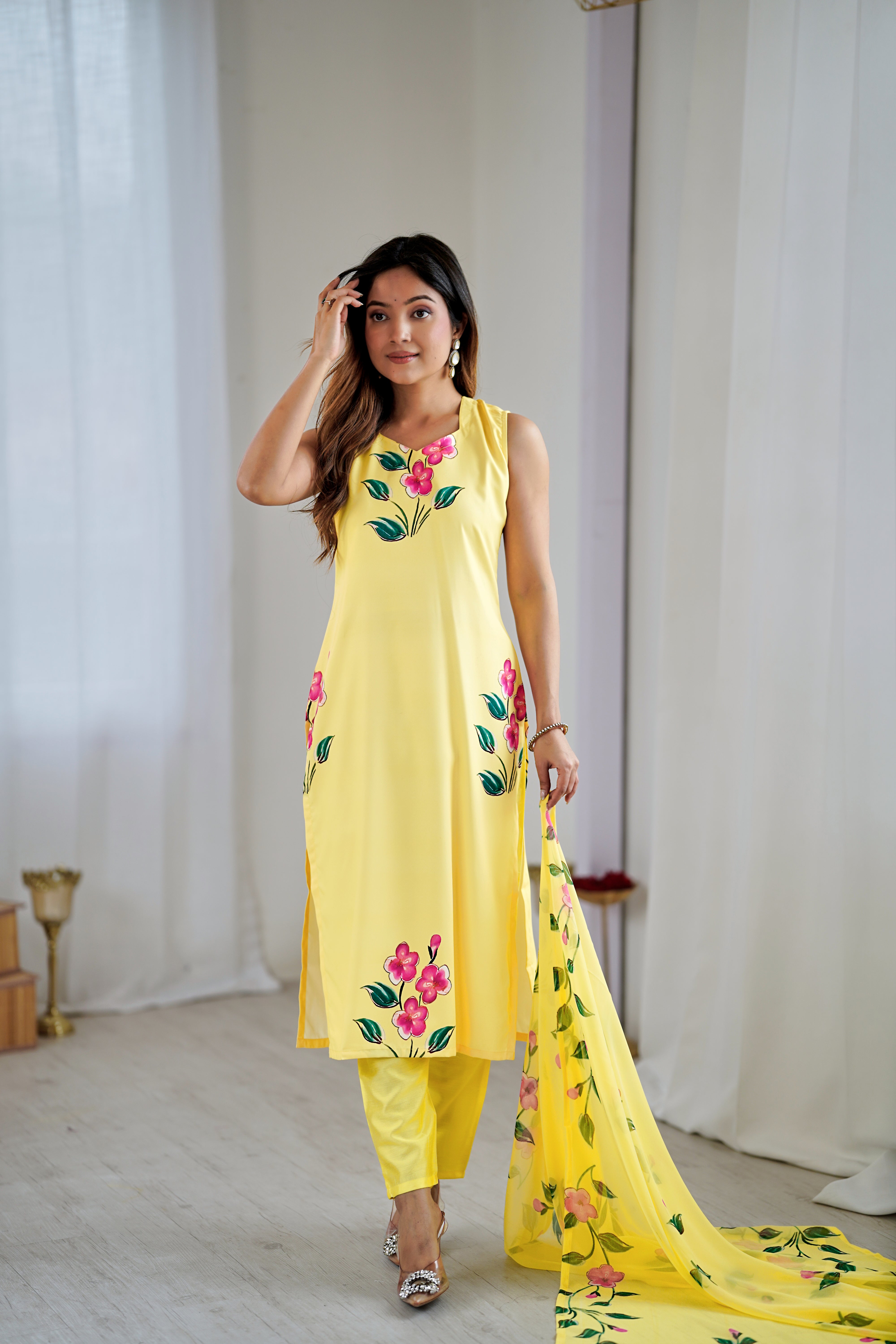 wearing a yellow embroidered outfit .