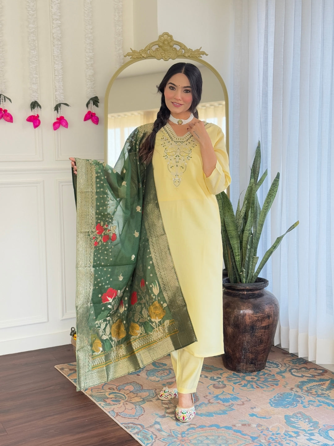 Woman in a yellow outfit with a green dupatta