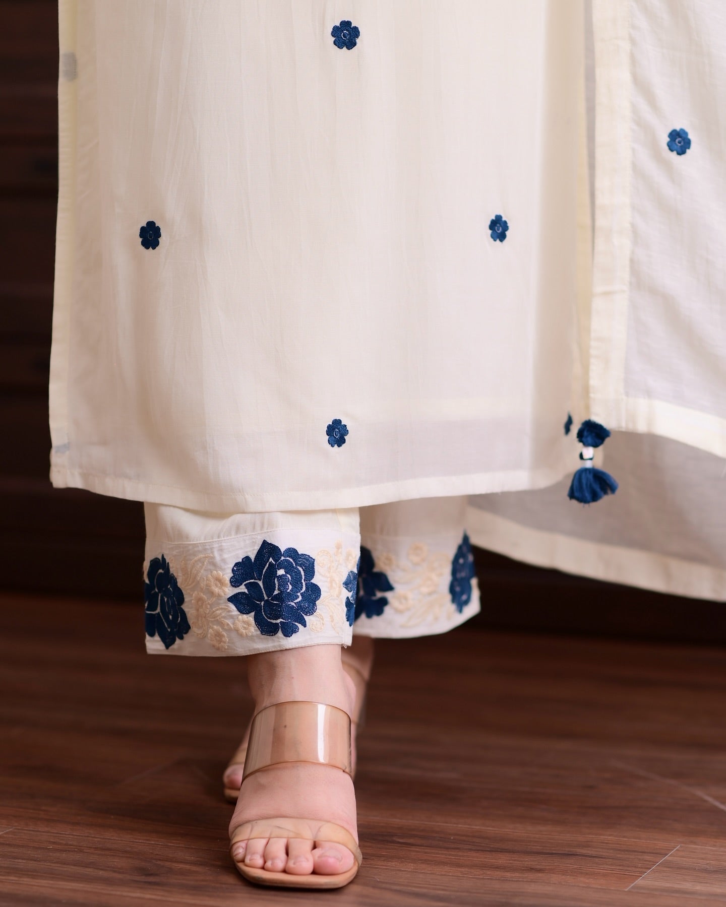 Elegant white outfit adorned with delicate blue floral patterns.