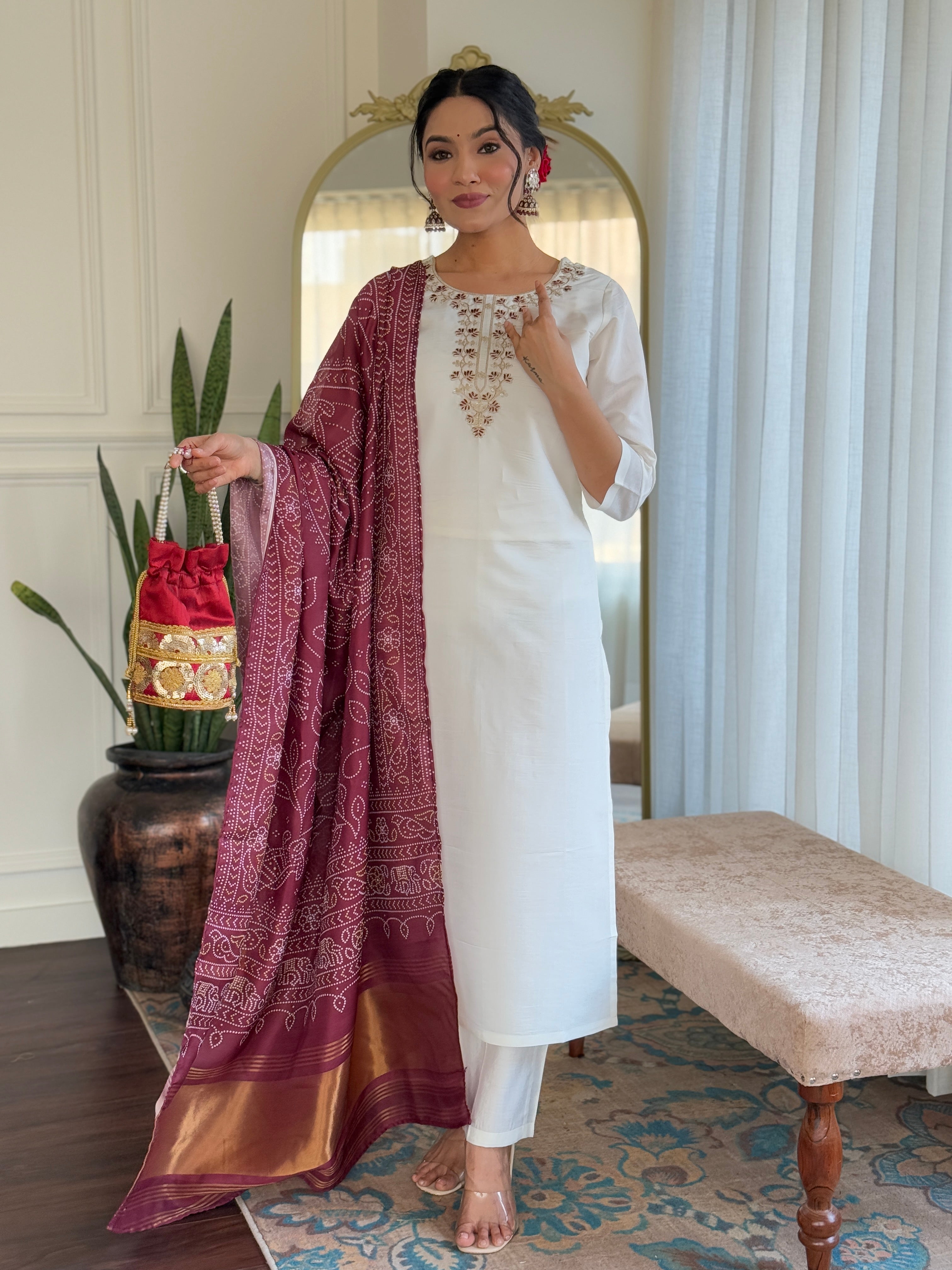 white traditional outfit with a maroon dupatta 