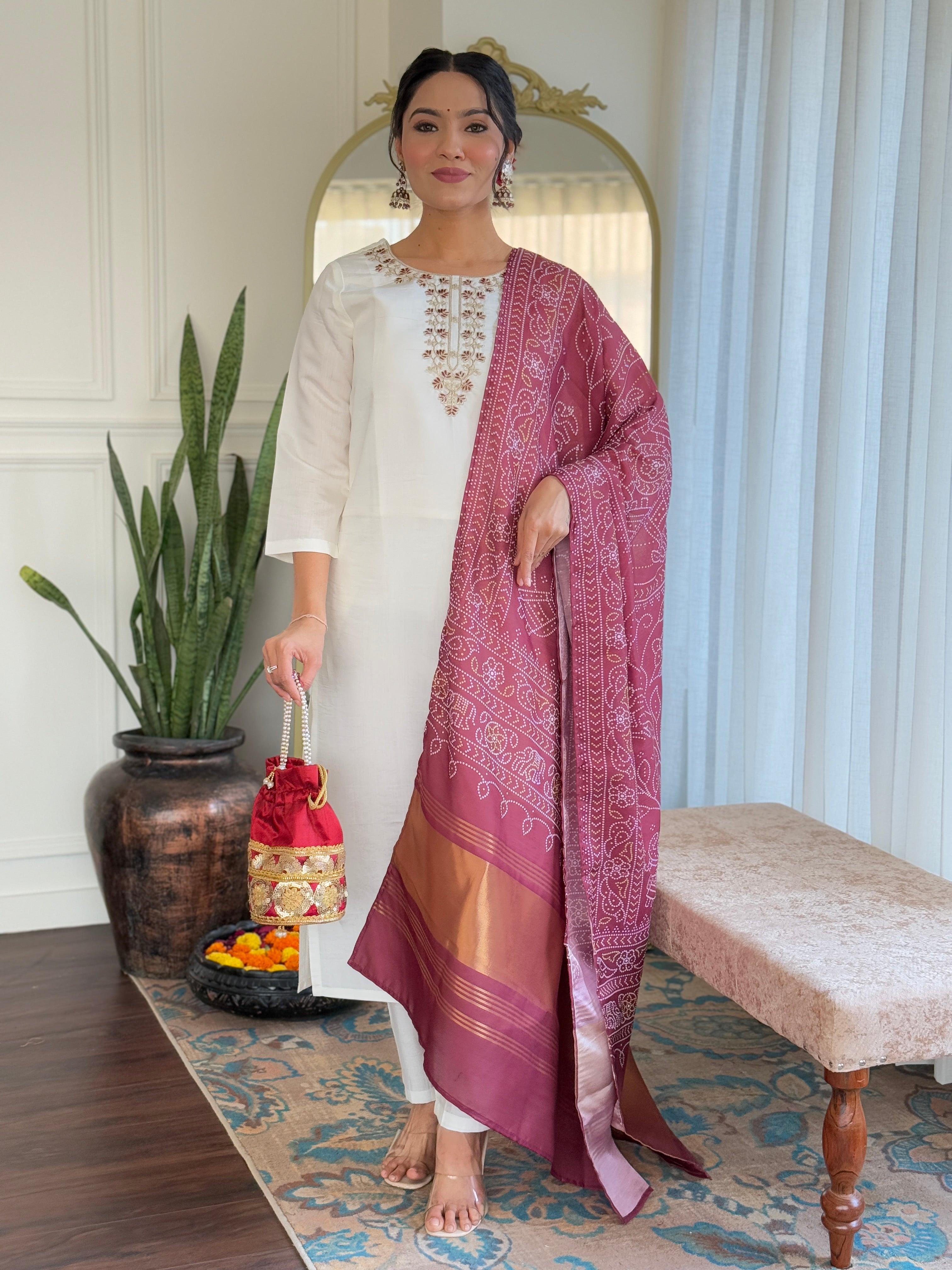 Elegant white embroidered traditional outfit paired with a rich maroon dupatta