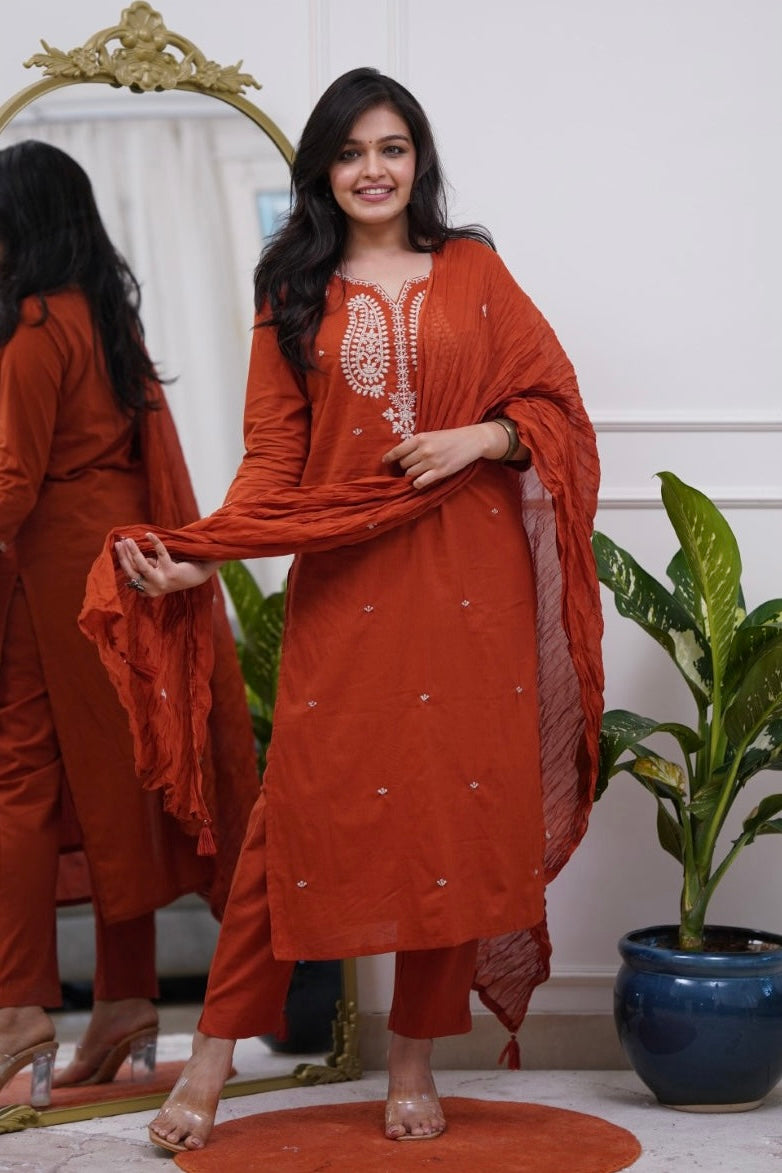 Woman in a rust-colored traditional outfit .