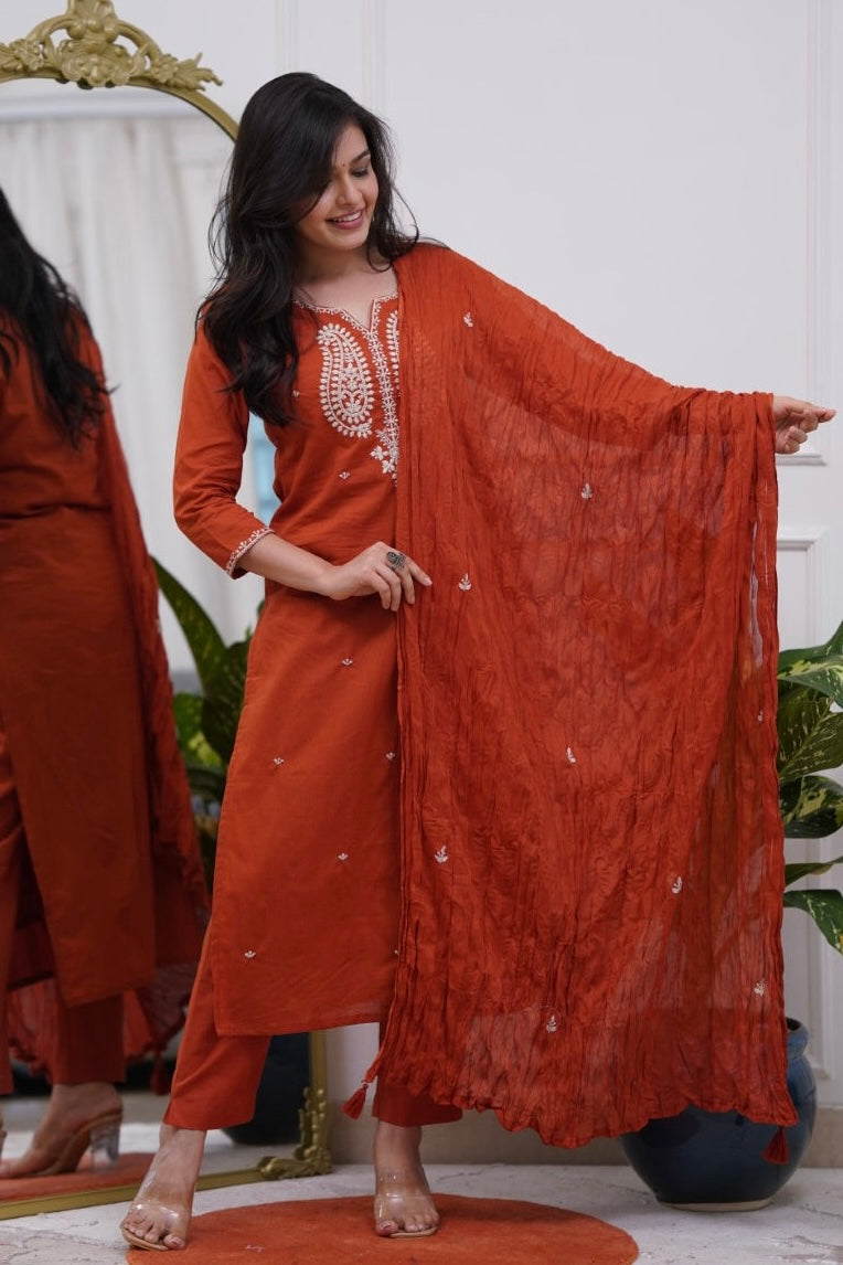 Woman in a rust-colored traditional outfit .