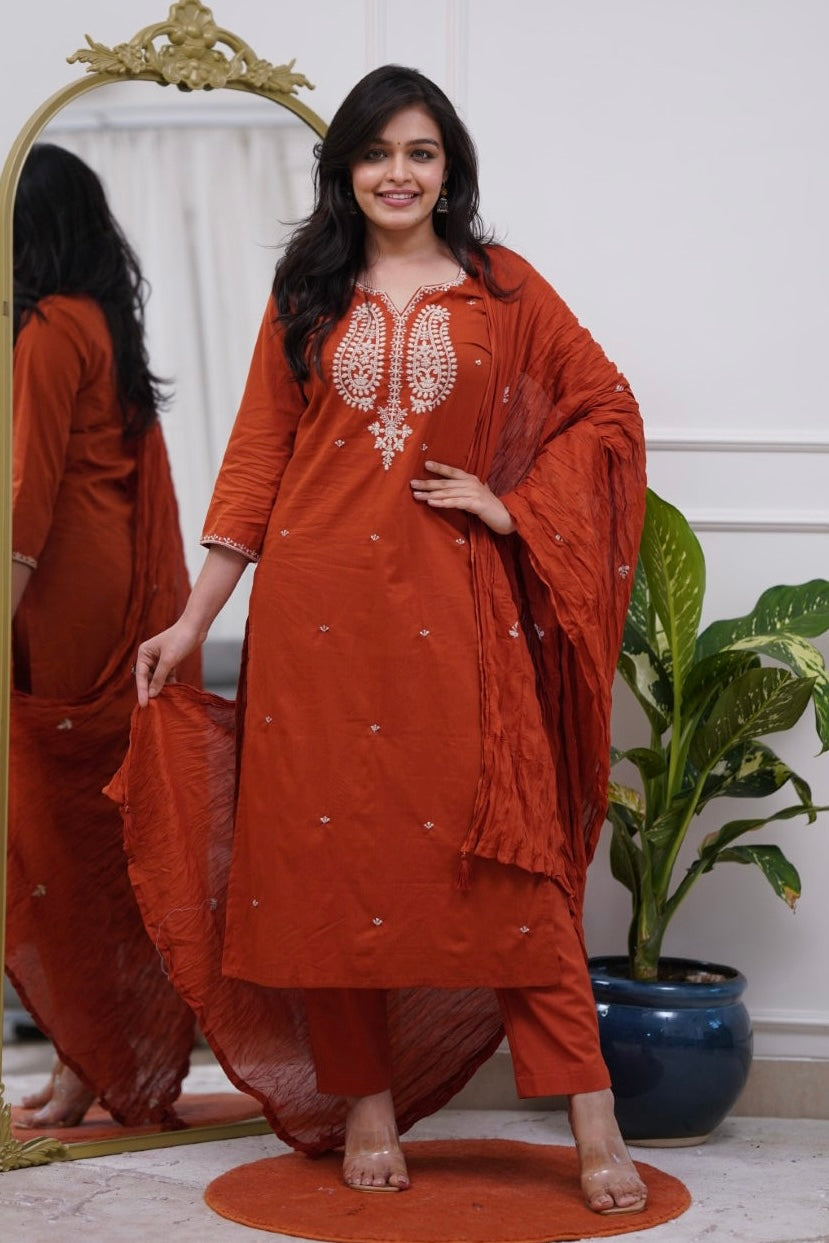 Woman in a rust-colored traditional outfit .