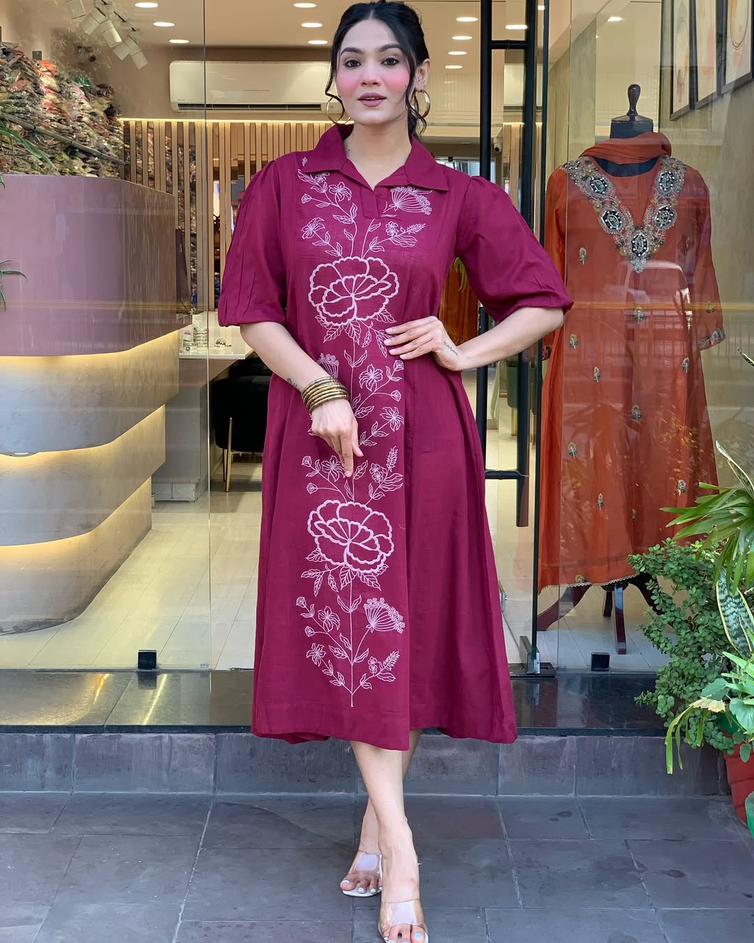 Woman wearing a berry colour kurti