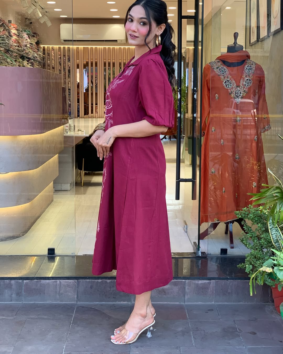 Woman wearing a berry colour kurti