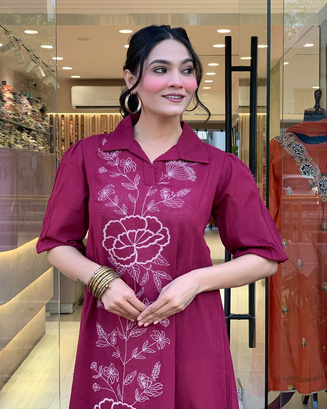 Woman wearing a berry colour kurti