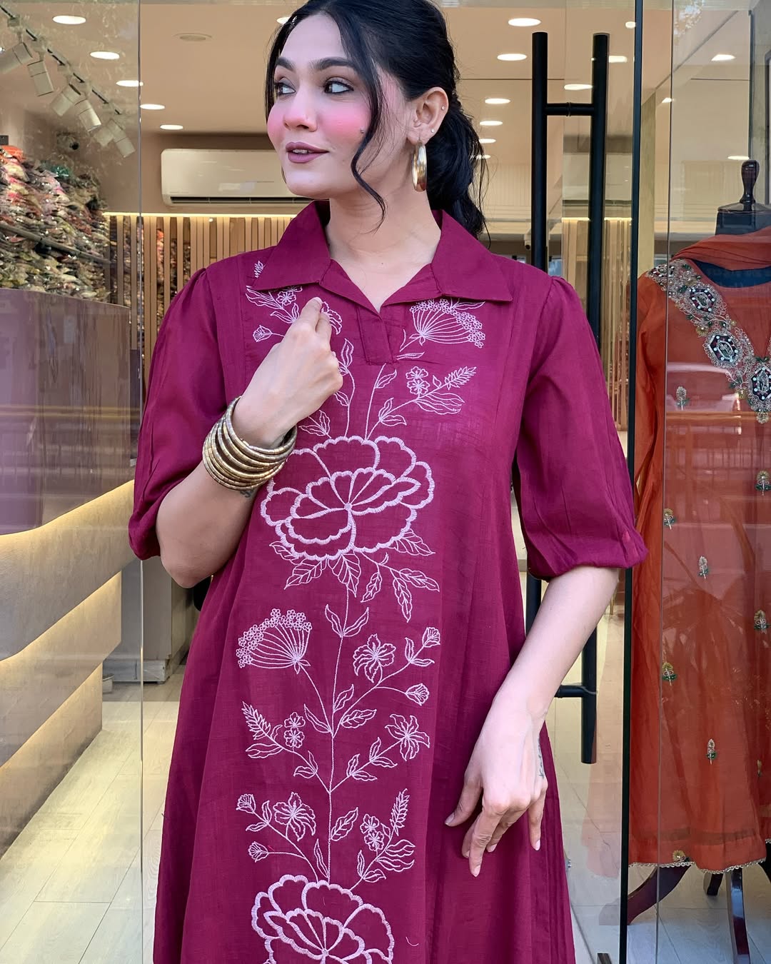 Woman wearing a berry colour kurti