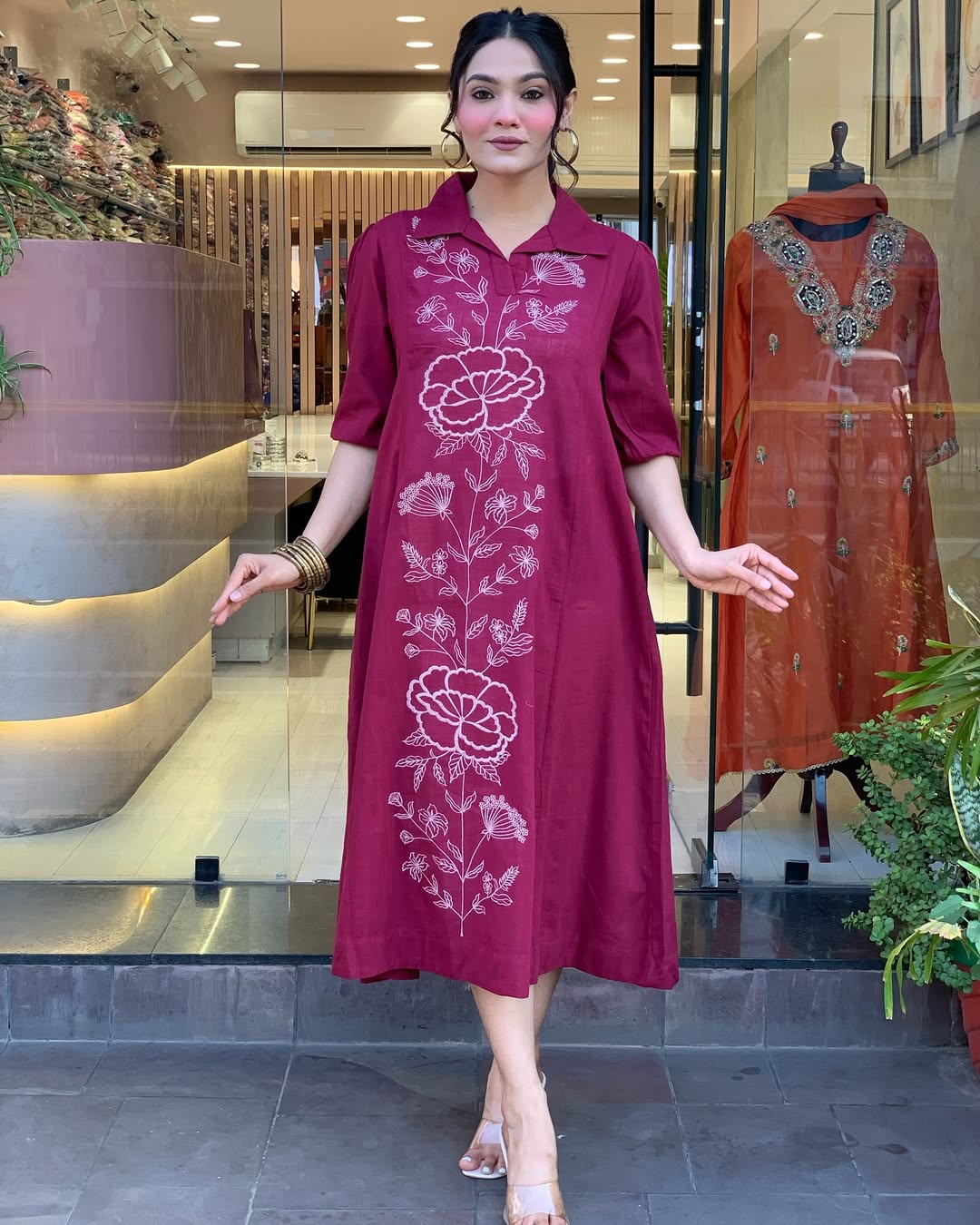 Woman wearing a berry colour kurti