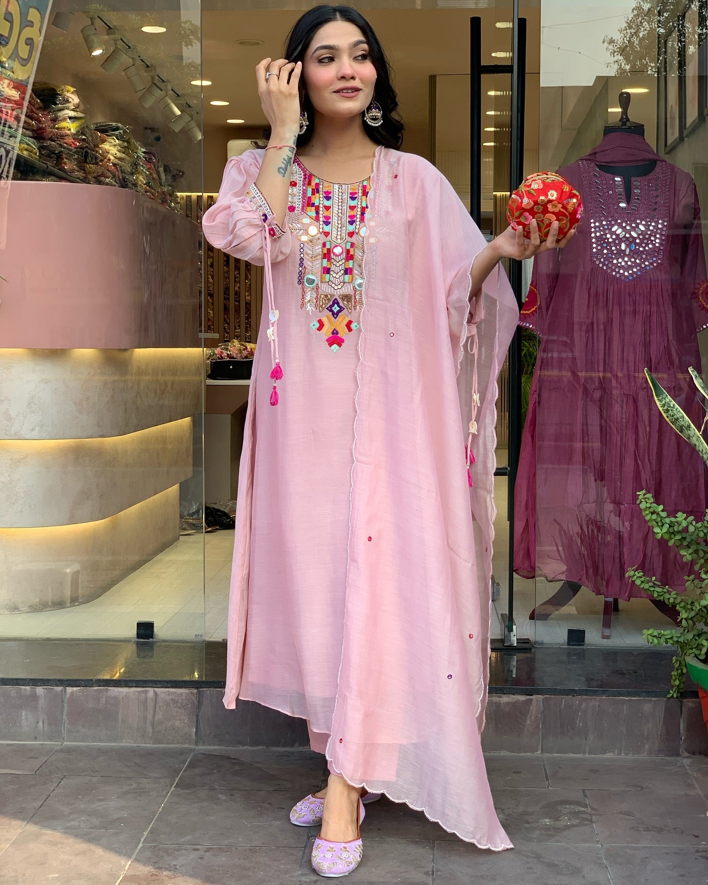 Woman in a light pink embroidered dress 