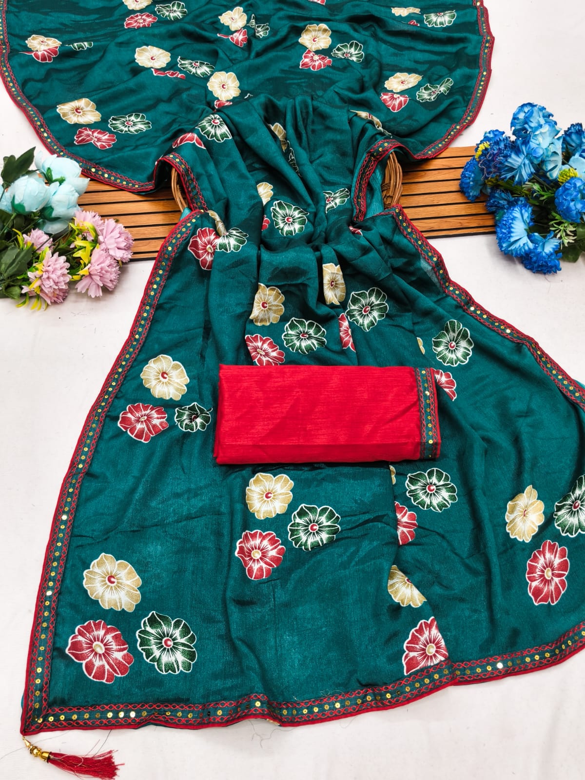 Elegant sarees with sequined borders and contrasting raw silk blouses.