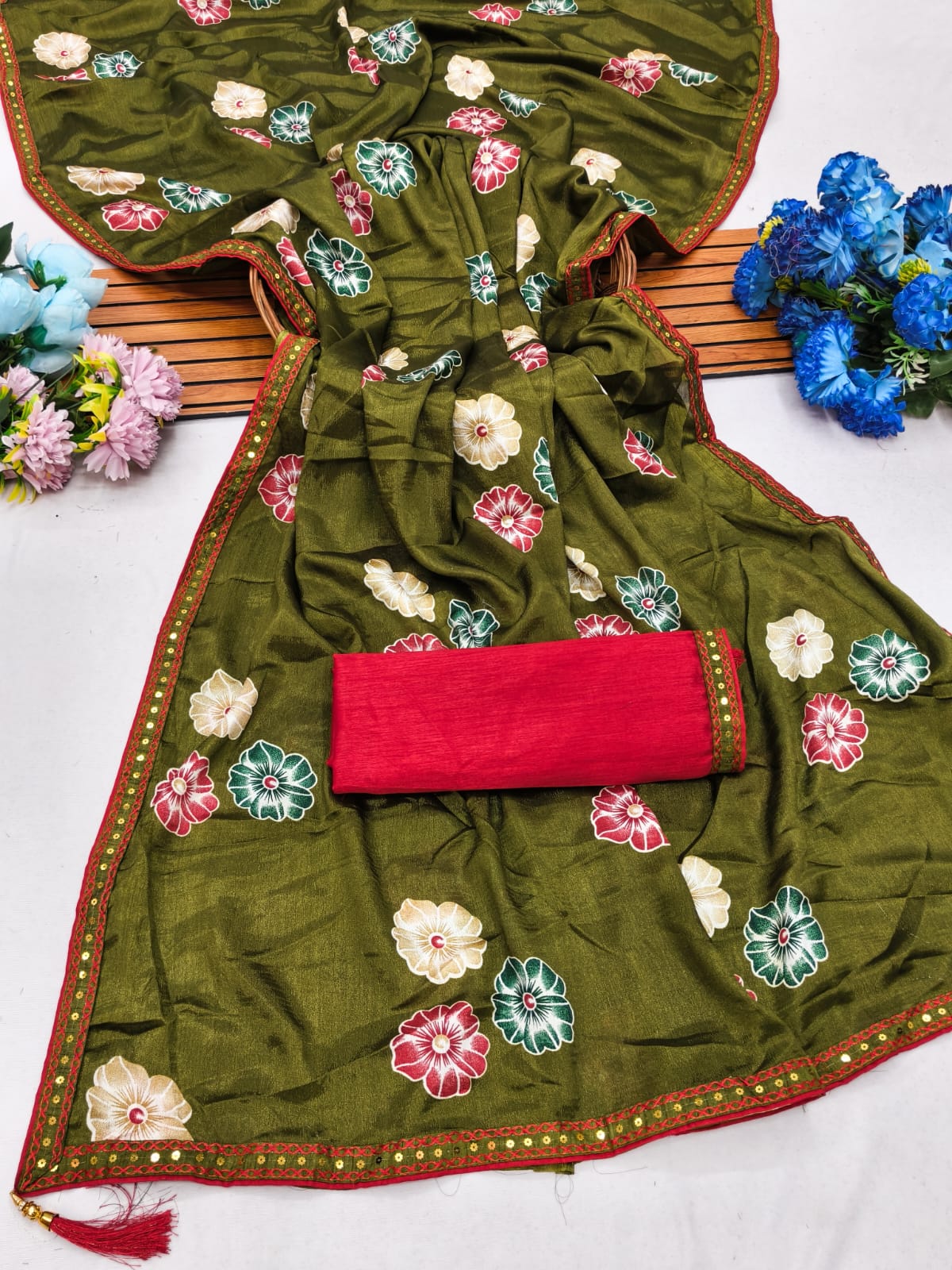 Elegant sarees with sequined borders and contrasting raw silk blouses.