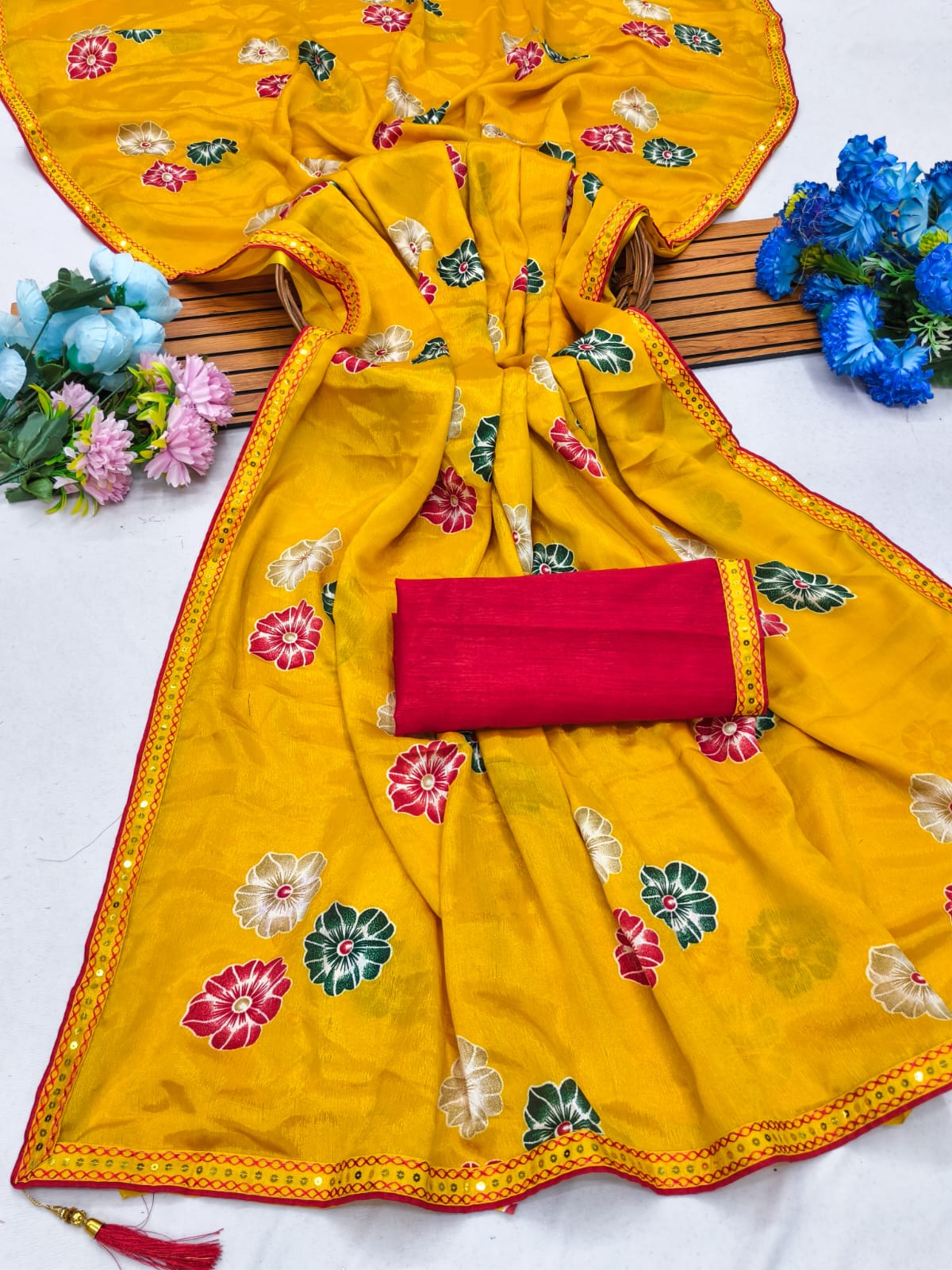 Elegant sarees with sequined borders and contrasting raw silk blouses.