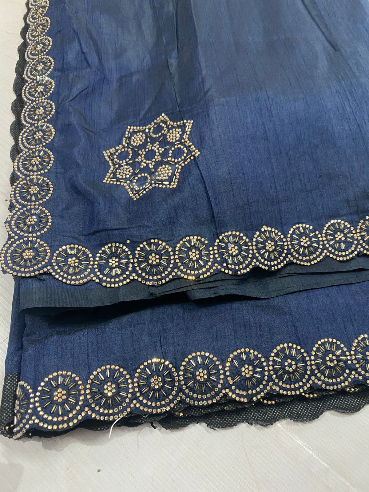 Blue fabric with intricate heavy beads work