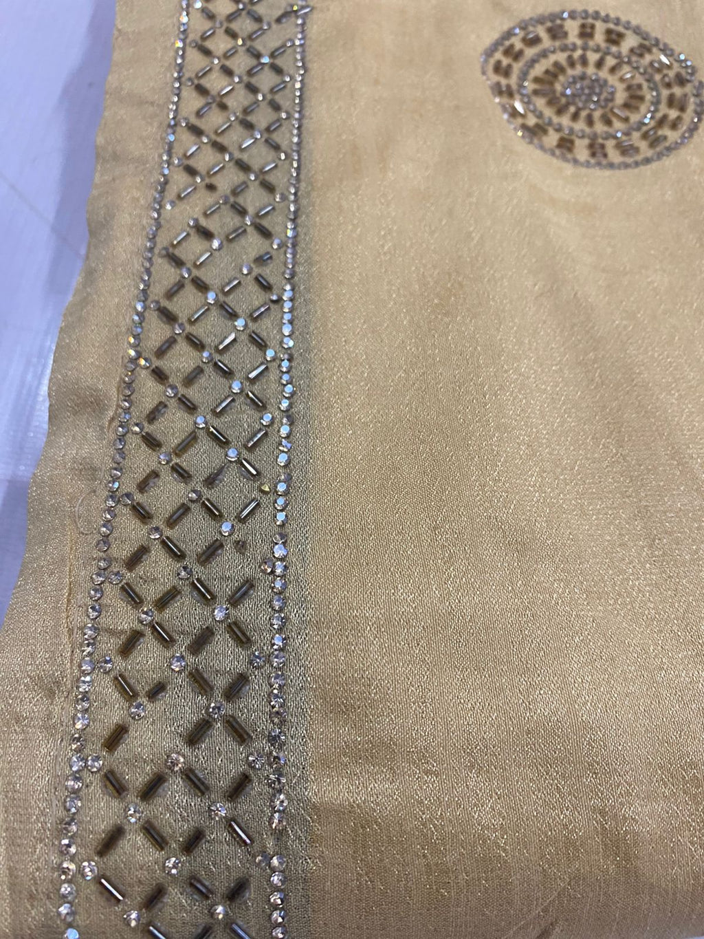 Beige saree with intricate work bread
