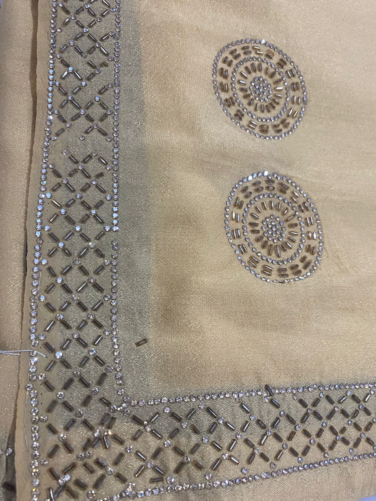Beige saree with intricate work bread